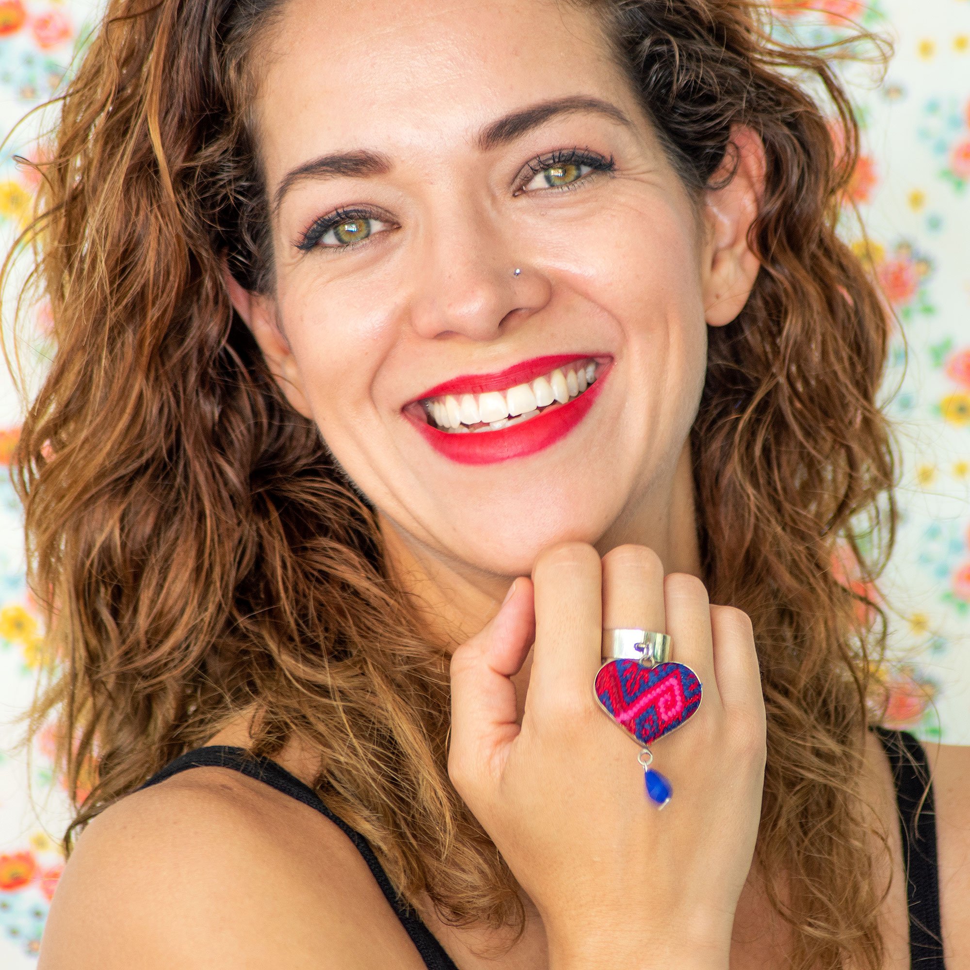 Folk Ring featuring a hanging heart pendant and colorful embroidered textile, handcrafted in Chiapas, Mexico.