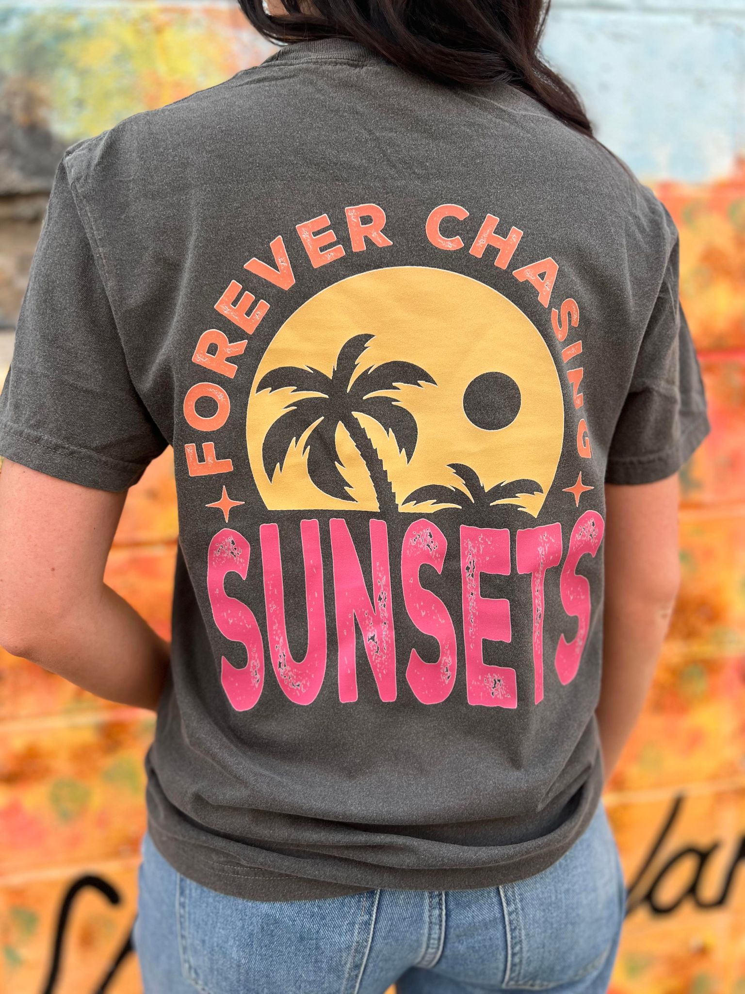 A stylish Forever Chasing Sunsets Tee in Pepper color, made from 100% cotton with a vibrant DTF printed design.