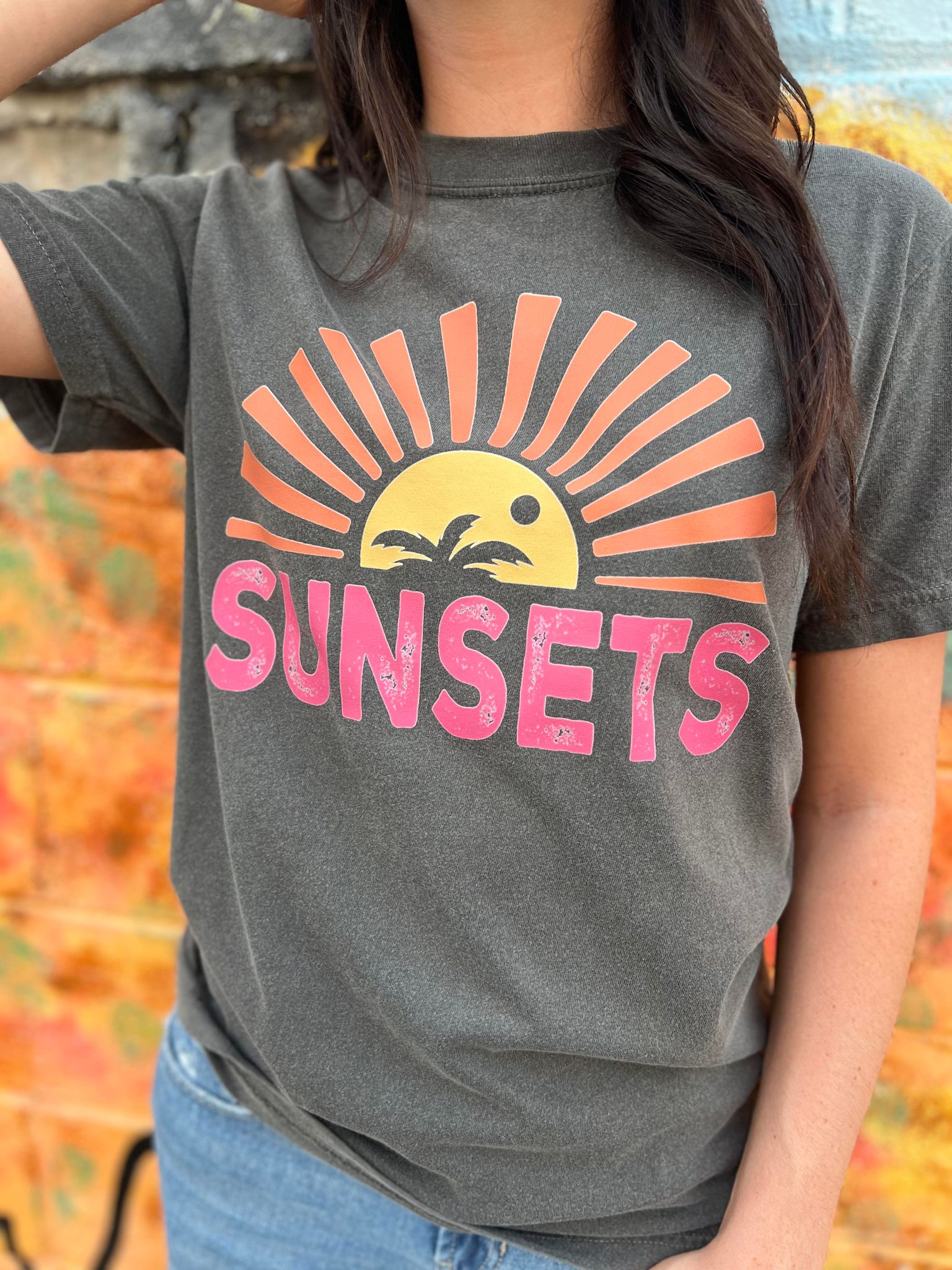 A stylish Forever Chasing Sunsets Tee in Pepper color, made from 100% cotton with a vibrant DTF printed design.