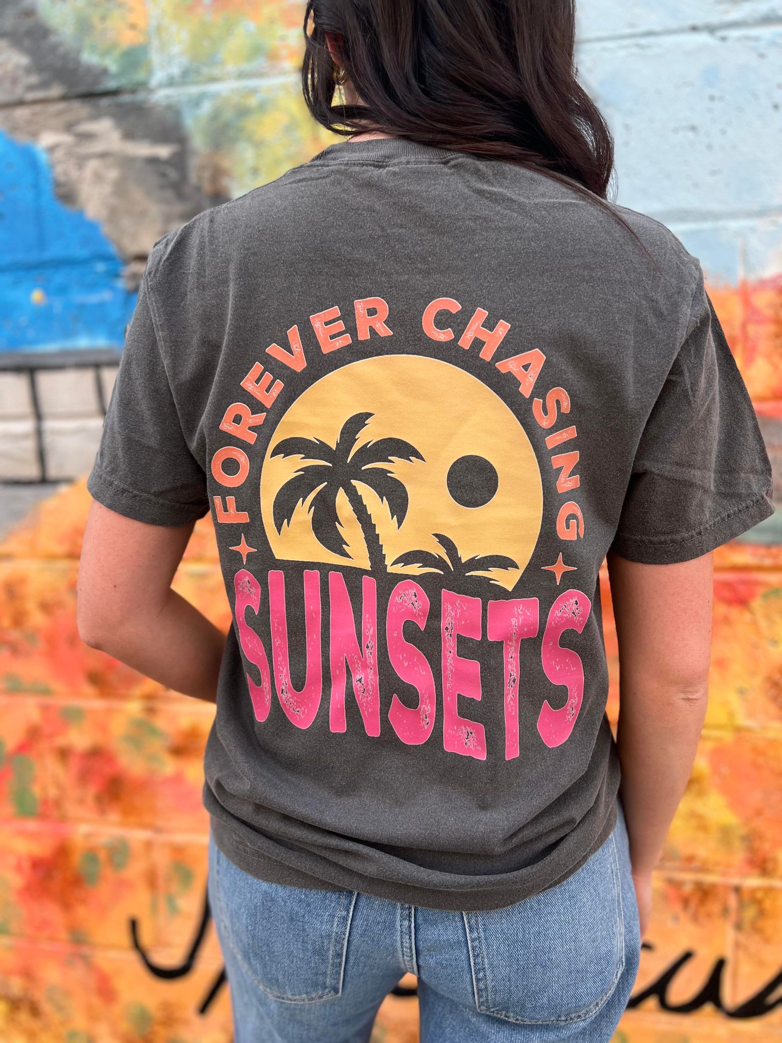 A stylish Forever Chasing Sunsets Tee in Pepper color, made from 100% cotton with a vibrant DTF printed design.