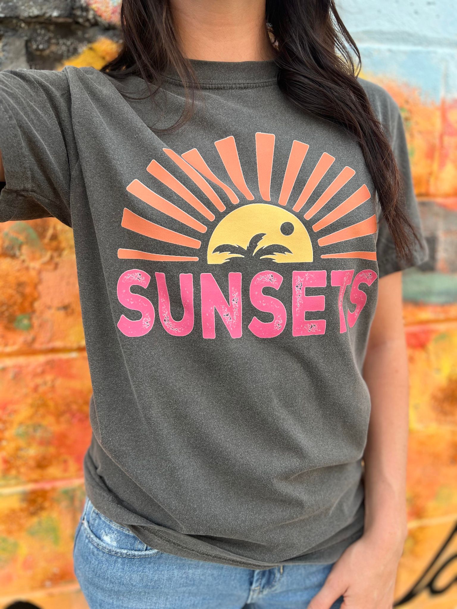 A stylish Forever Chasing Sunsets Tee in Pepper color, made from 100% cotton with a vibrant DTF printed design.