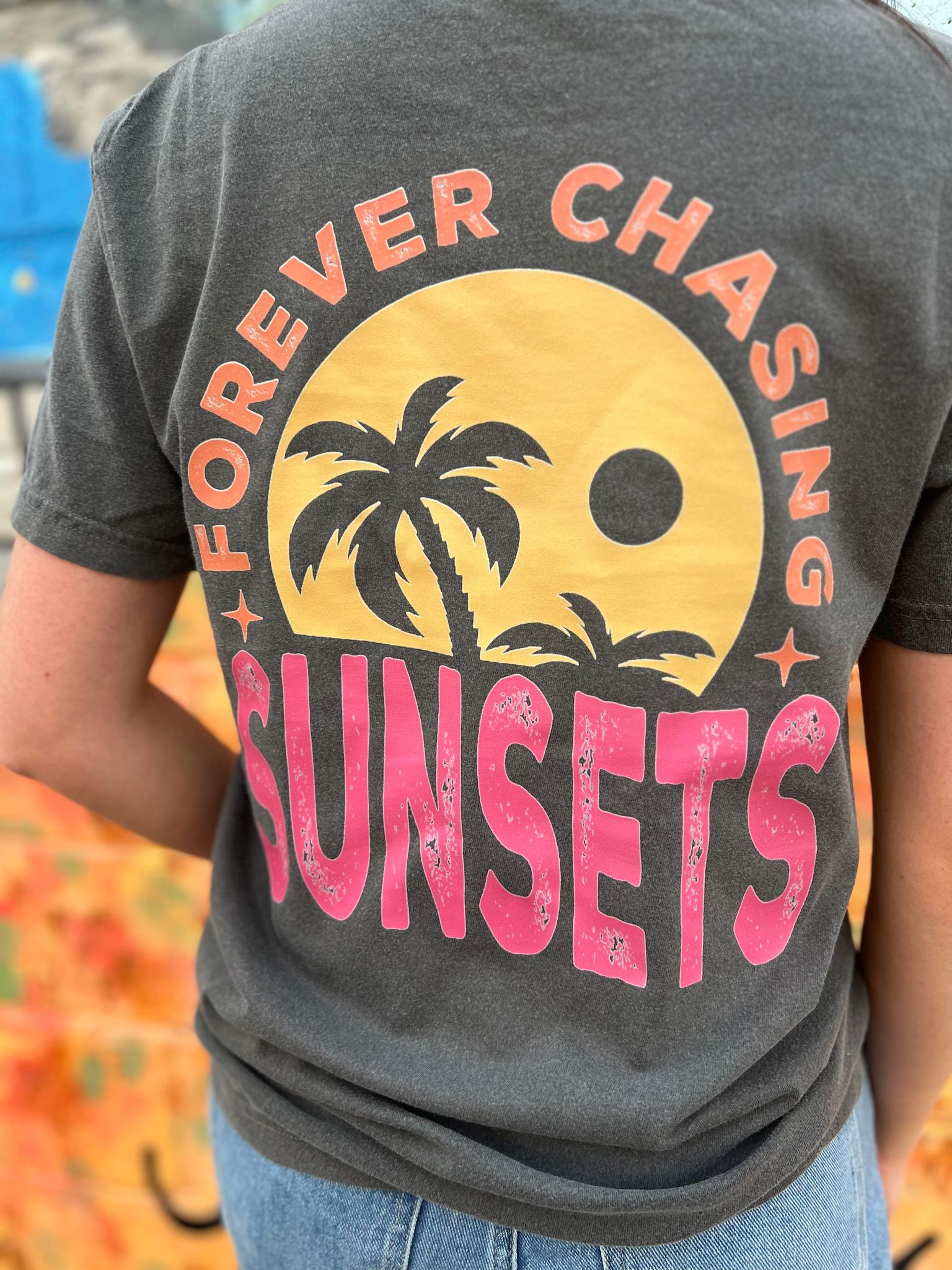 A stylish Forever Chasing Sunsets Tee in Pepper color, made from 100% cotton with a vibrant DTF printed design.