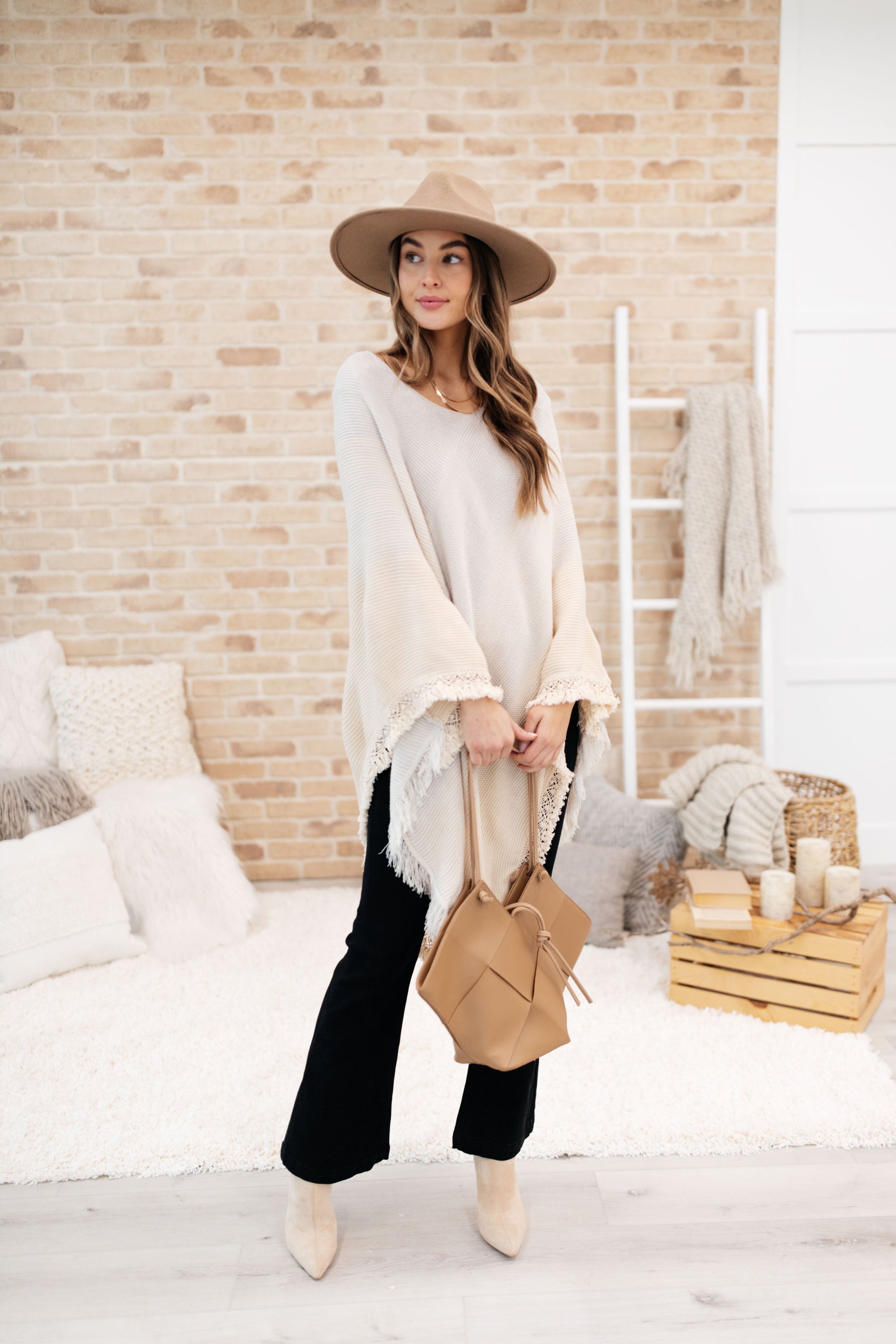 A stylish grey poncho with a color-blocked design and fringed edges, perfect for chilly days and cozy movie nights.