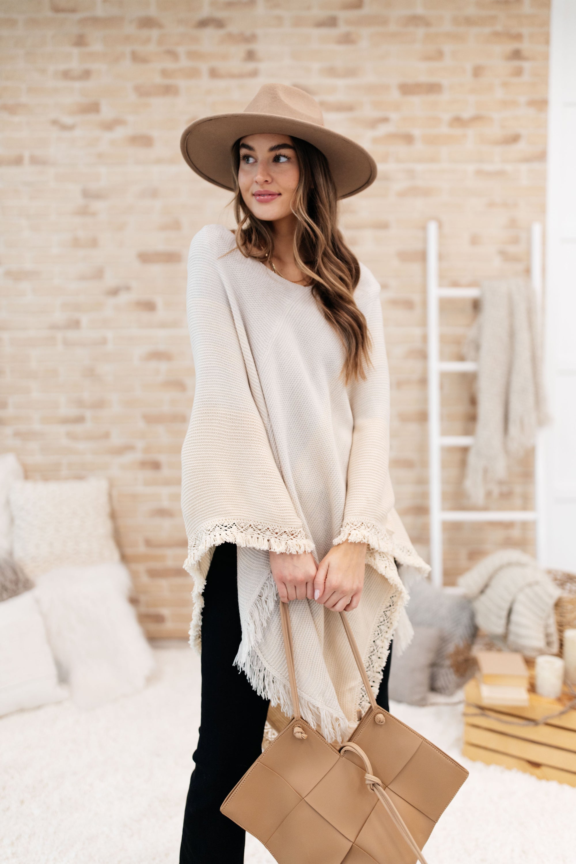 A stylish grey poncho with a color-blocked design and fringed edges, perfect for chilly days and cozy movie nights.