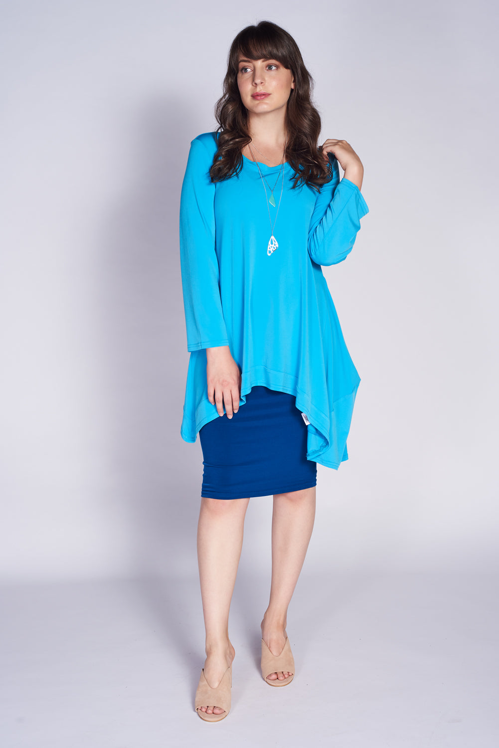 A stylish Forum Tunic featuring seam detailing, designed to flatter curves, made from a comfortable polyester and spandex blend.