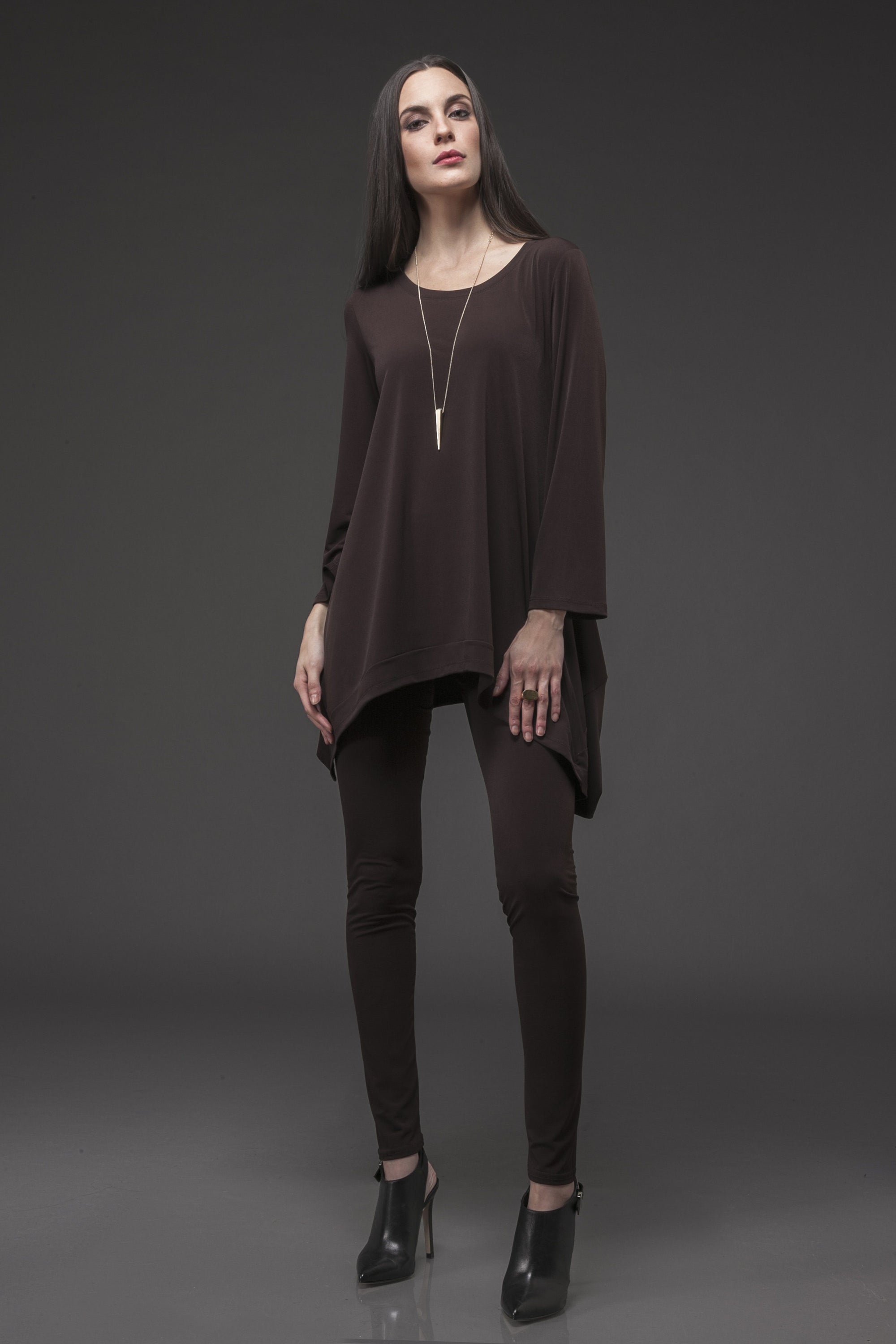 A stylish Forum Tunic featuring seam detailing, designed to flatter curves, made from a comfortable polyester and spandex blend.