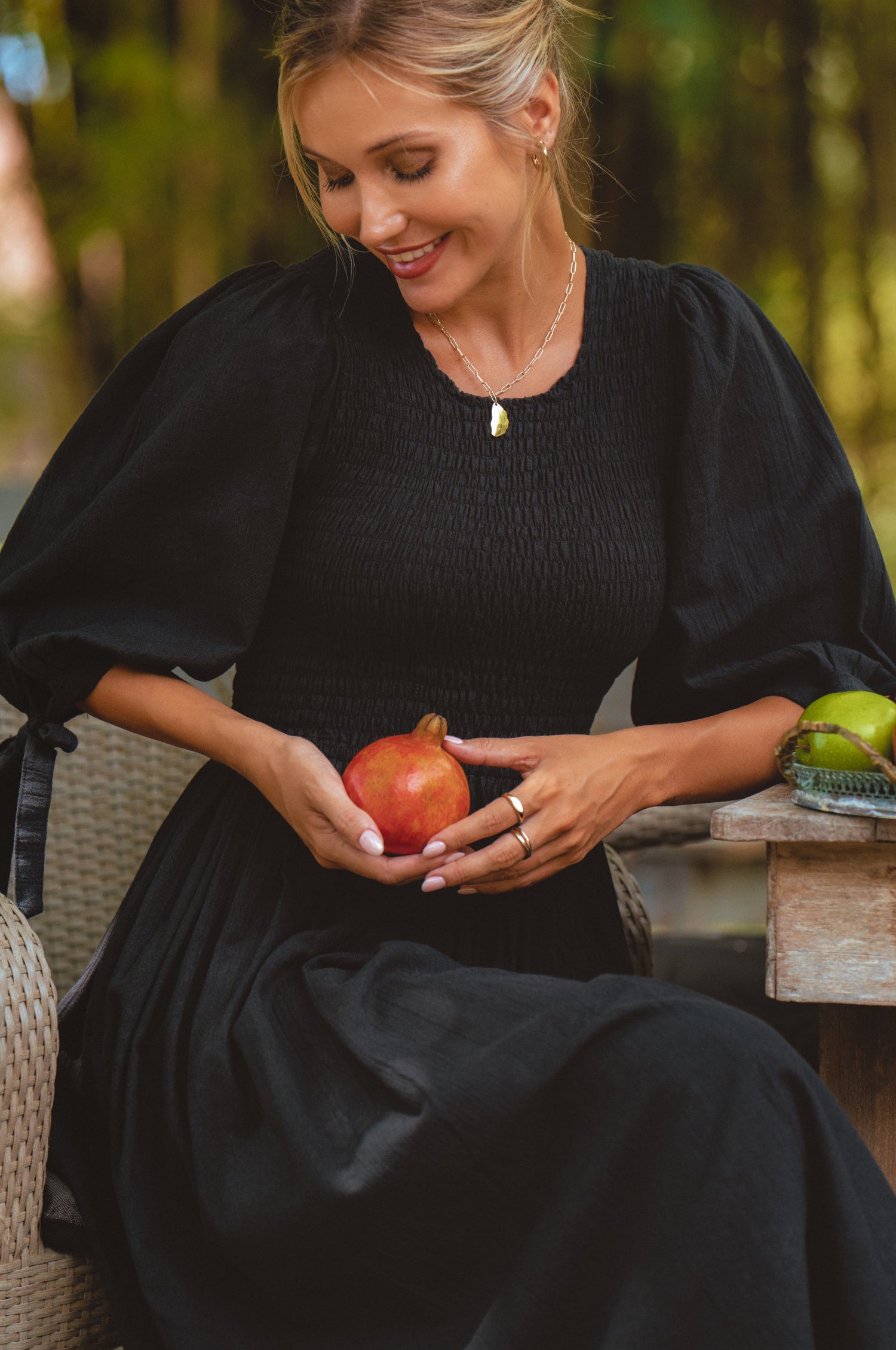 Freya Smocked Linen Midi Dress featuring a smocked bodice and tie-up puffy sleeves in a light crinkle linen fabric.