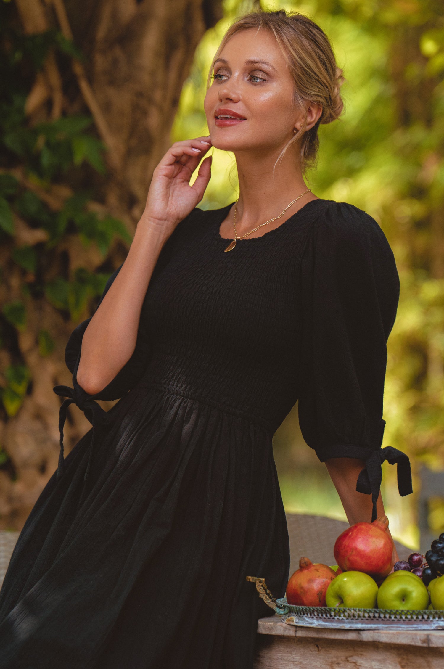 Freya Smocked Linen Midi Dress featuring a smocked bodice and tie-up puffy sleeves in a light crinkle linen fabric.