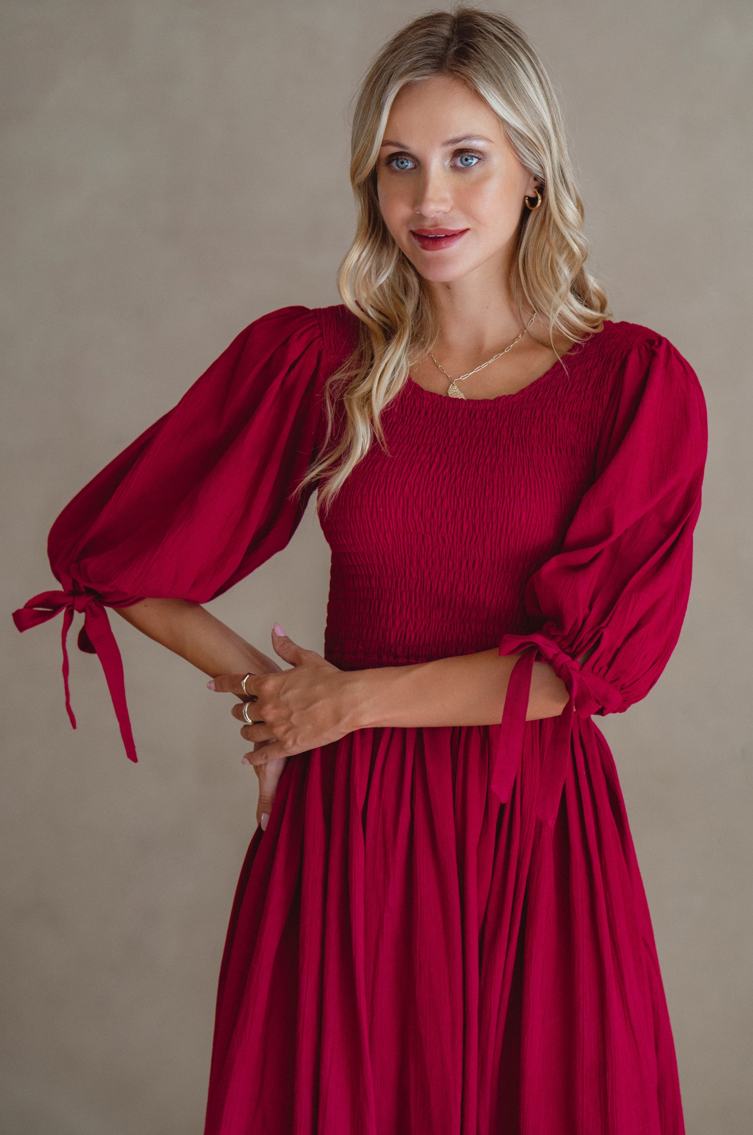 Freya Smocked Linen Midi Dress featuring a smocked bodice and tie-up puffy sleeves in a light crinkle linen fabric.