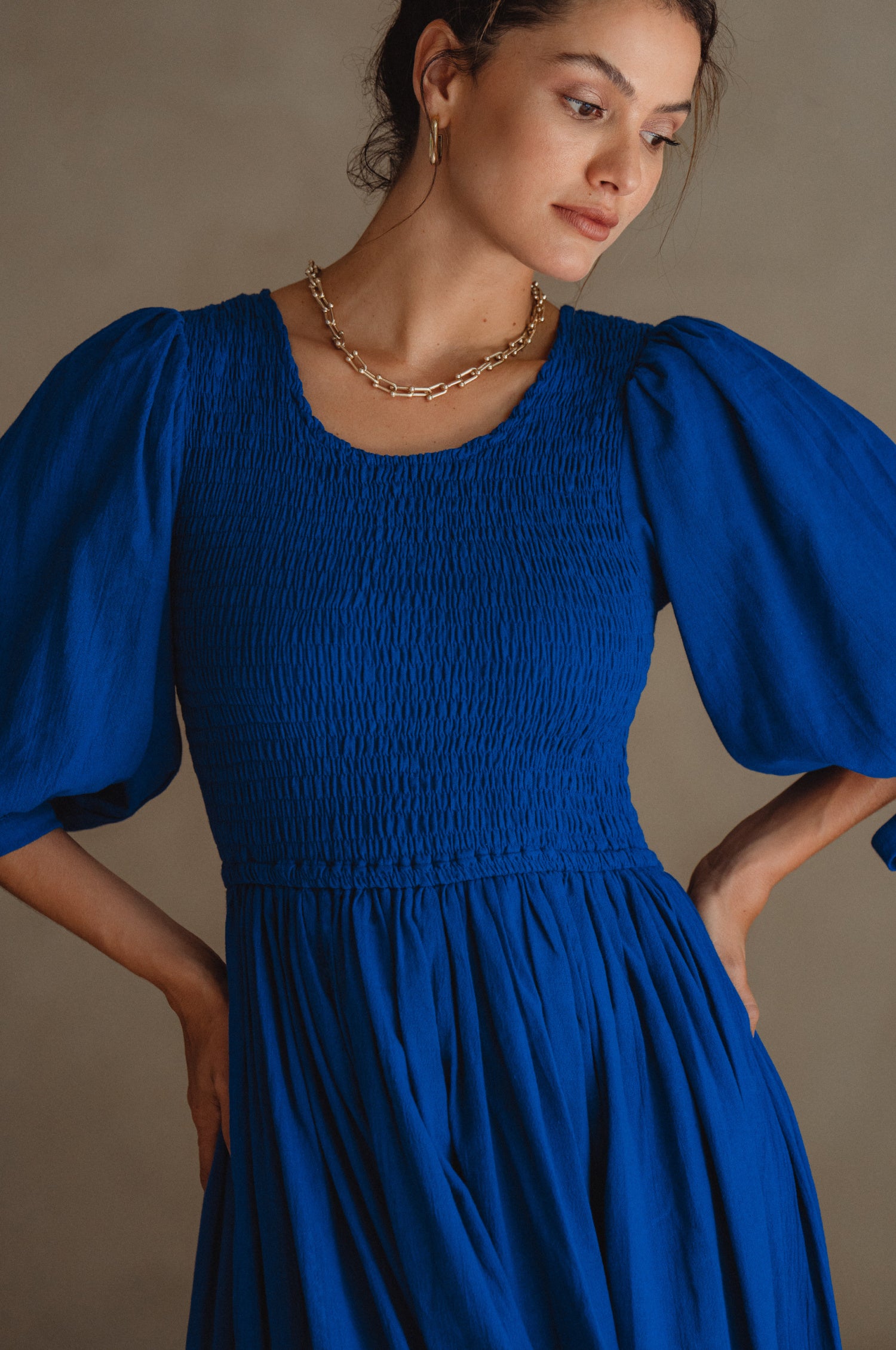 Freya Smocked Linen Midi Dress featuring a smocked bodice and tie-up puffy sleeves in a light crinkle linen fabric.