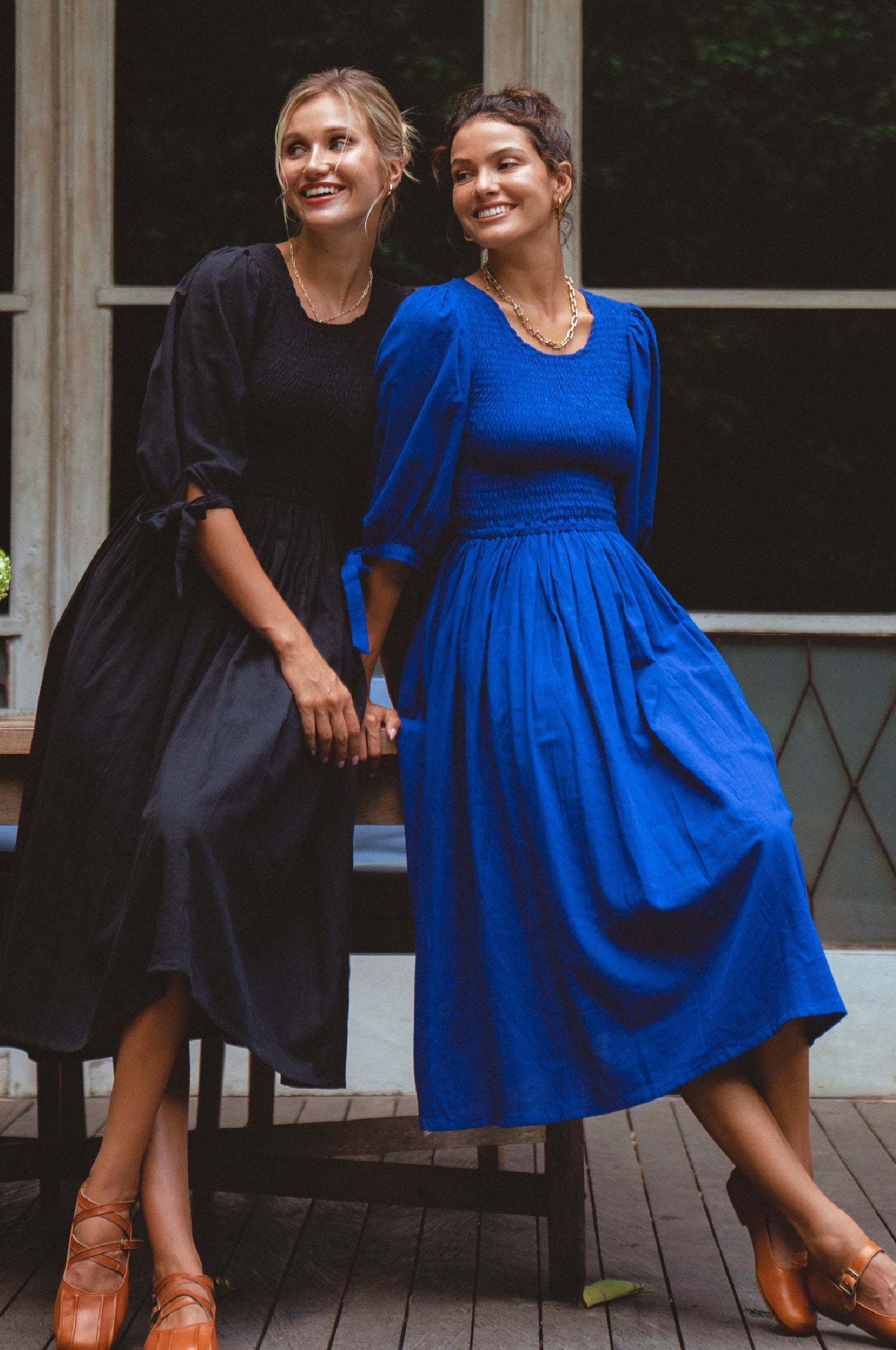 Freya Smocked Linen Midi Dress featuring a smocked bodice and tie-up puffy sleeves in a light crinkle linen fabric.