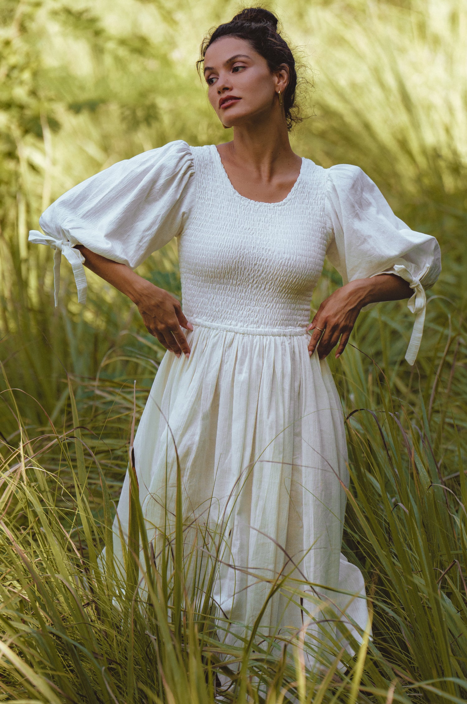 Freya Smocked Linen Midi Dress featuring a smocked bodice and tie-up puffy sleeves in a light crinkle linen fabric.