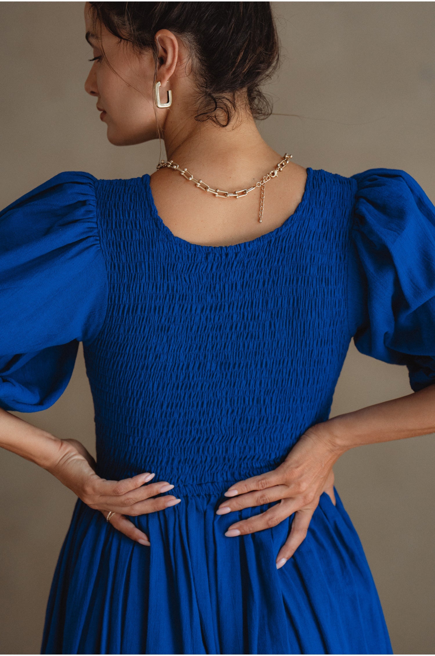 Freya Smocked Linen Midi Dress featuring a smocked bodice and tie-up puffy sleeves in a beautiful crinkle linen fabric.