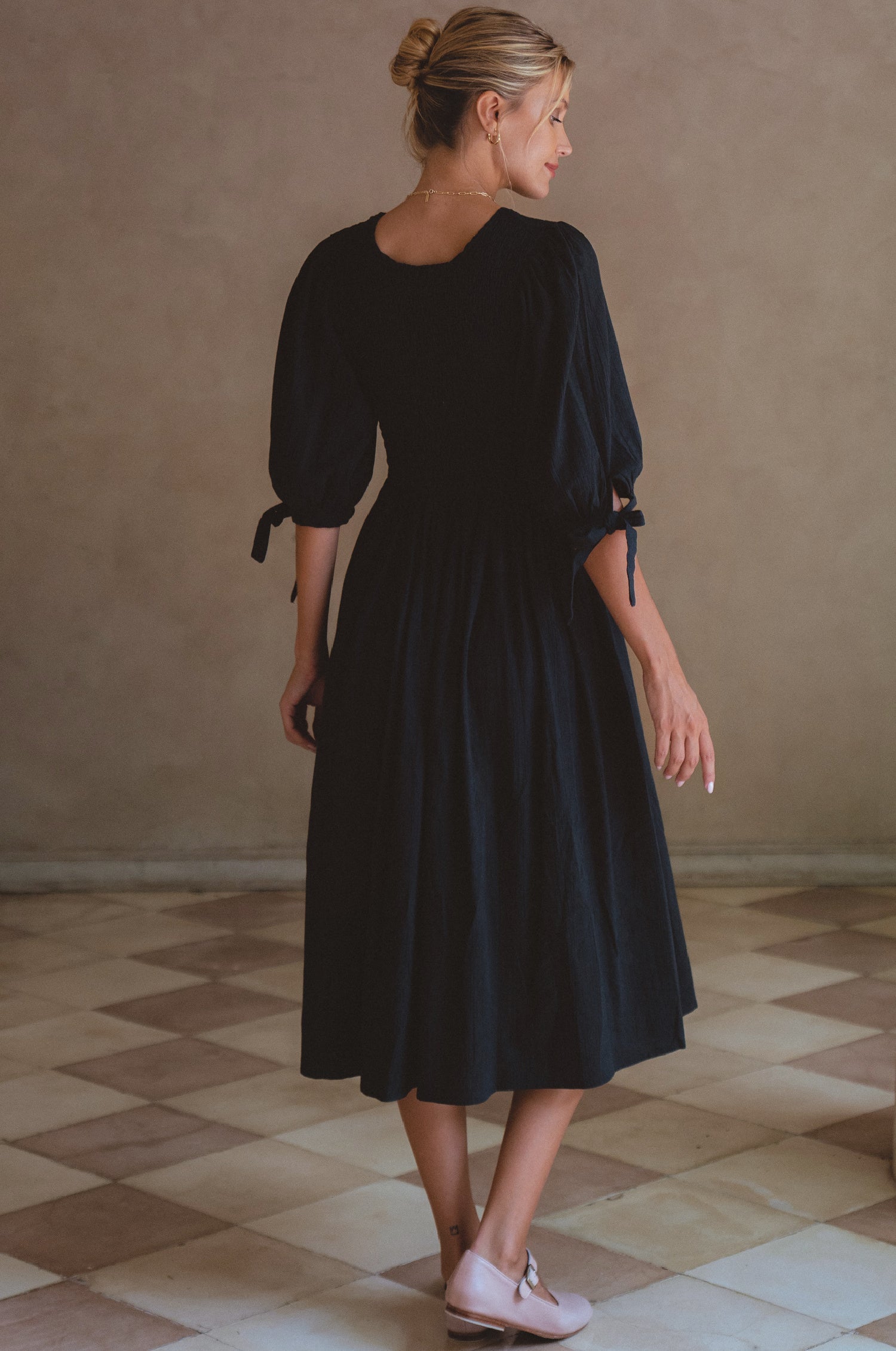 Freya Smocked Linen Midi Dress featuring a smocked bodice and tie-up puffy sleeves, made from high-quality crinkle linen.