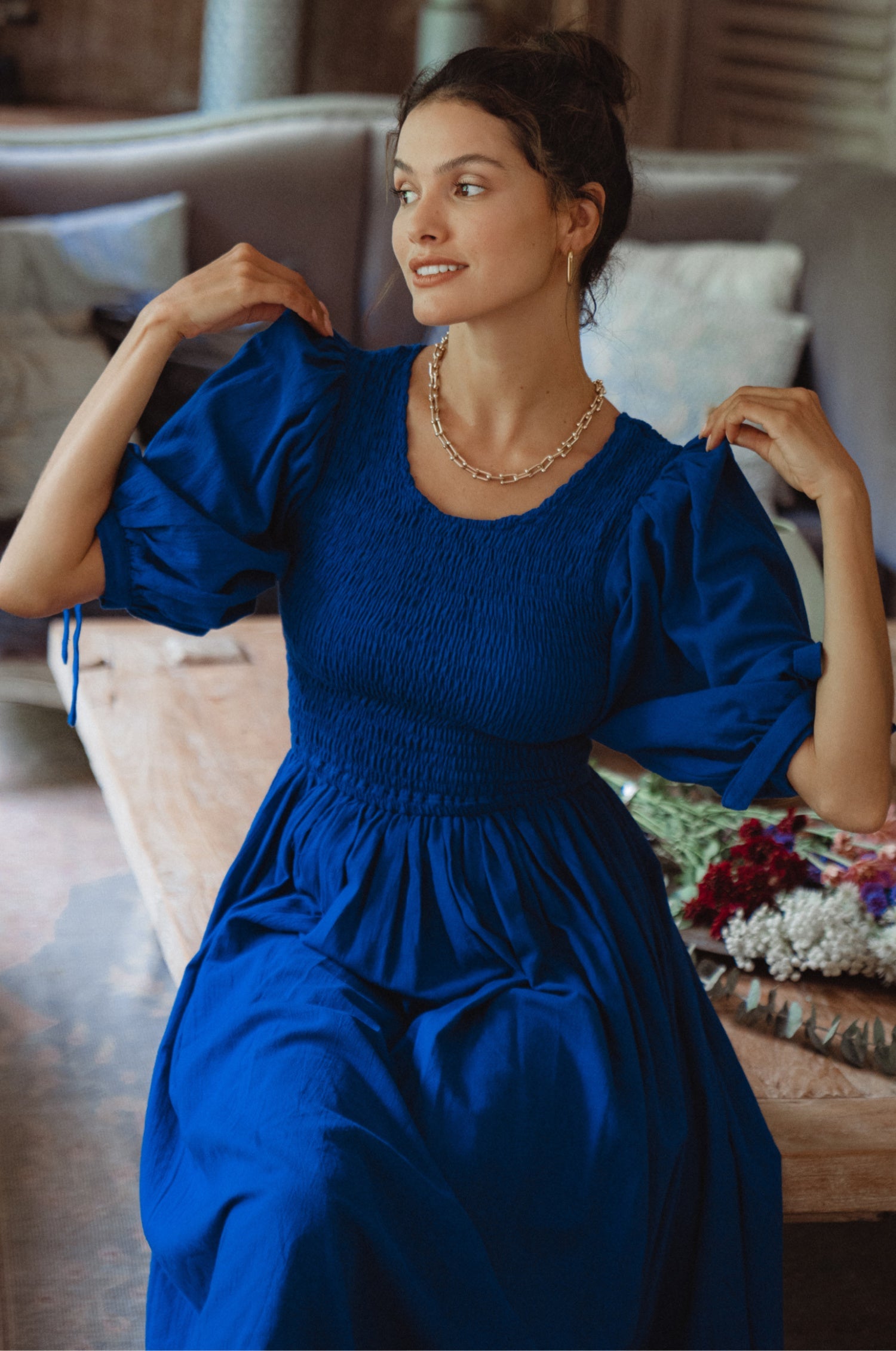 Freya Smocked Linen Midi Dress featuring a smocked bodice and tie-up puffy sleeves, made from high-quality crinkle linen.