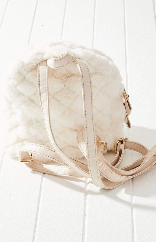 Freycinet Quilted Mini Backpack featuring plush vegan fur and leather trim, showcasing diamond quilting and adjustable straps.