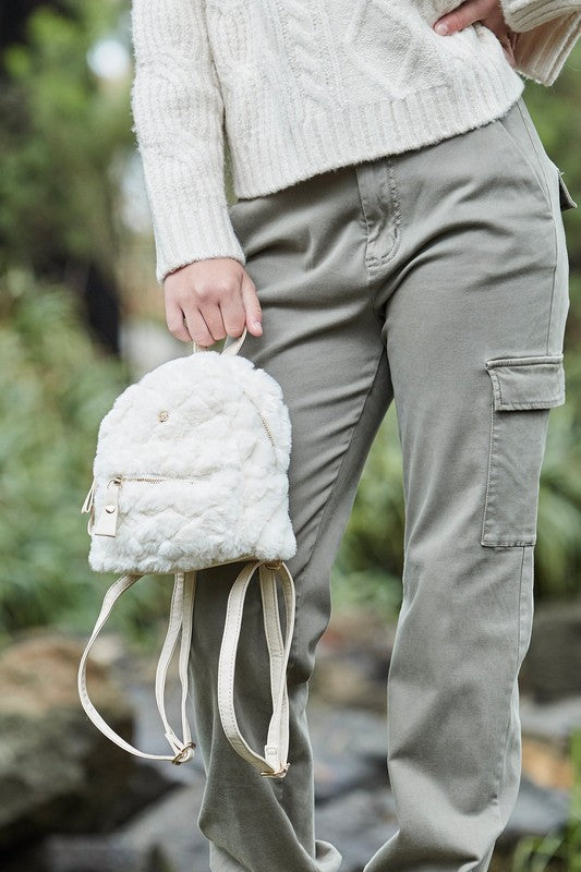 Freycinet Quilted Mini Backpack featuring plush vegan fur and leather trim, showcasing diamond quilting and adjustable straps.