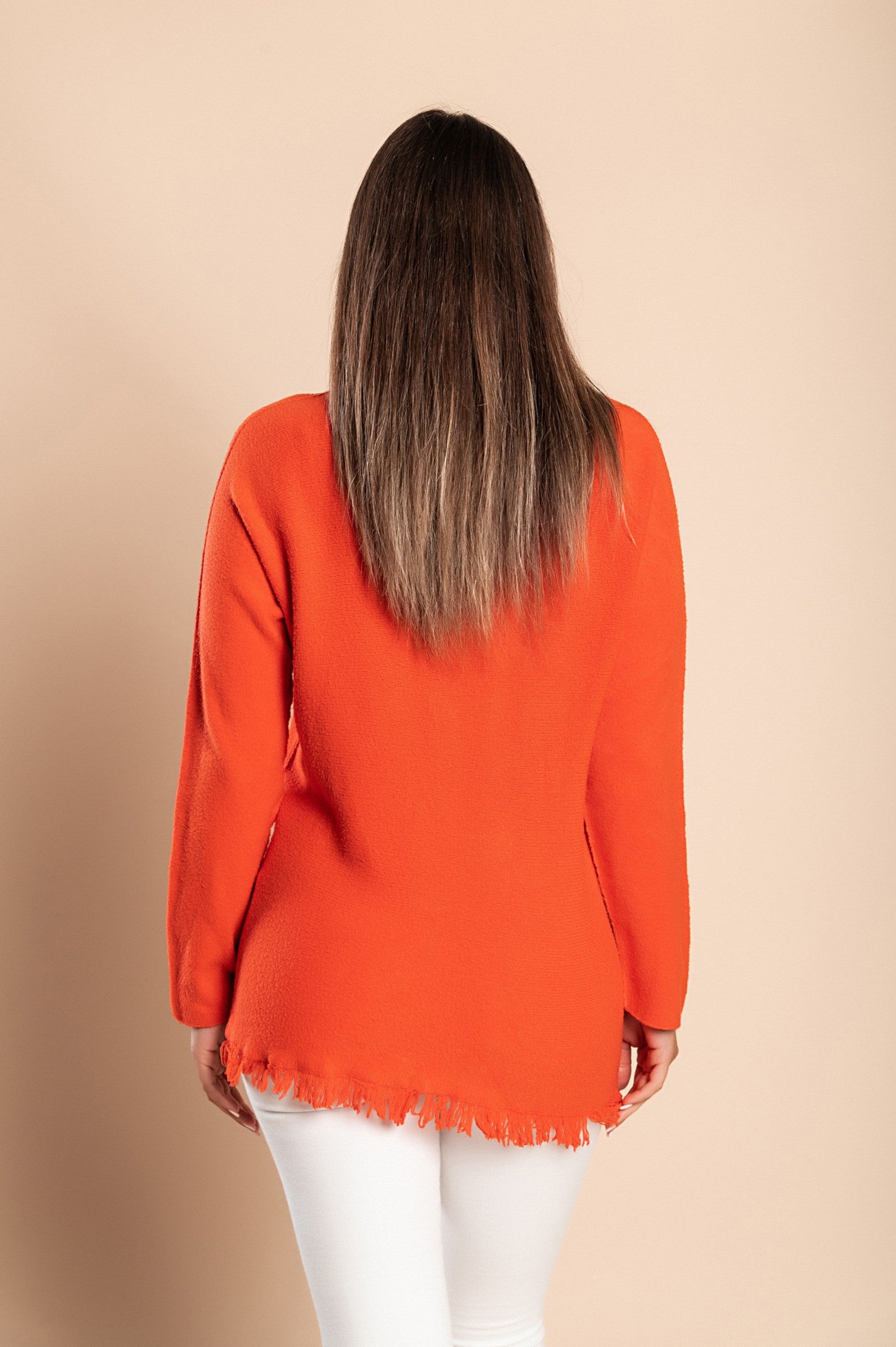 Stylish orange fringed jumper with V-neckline and long sleeves, showcasing a soft knitwear texture.