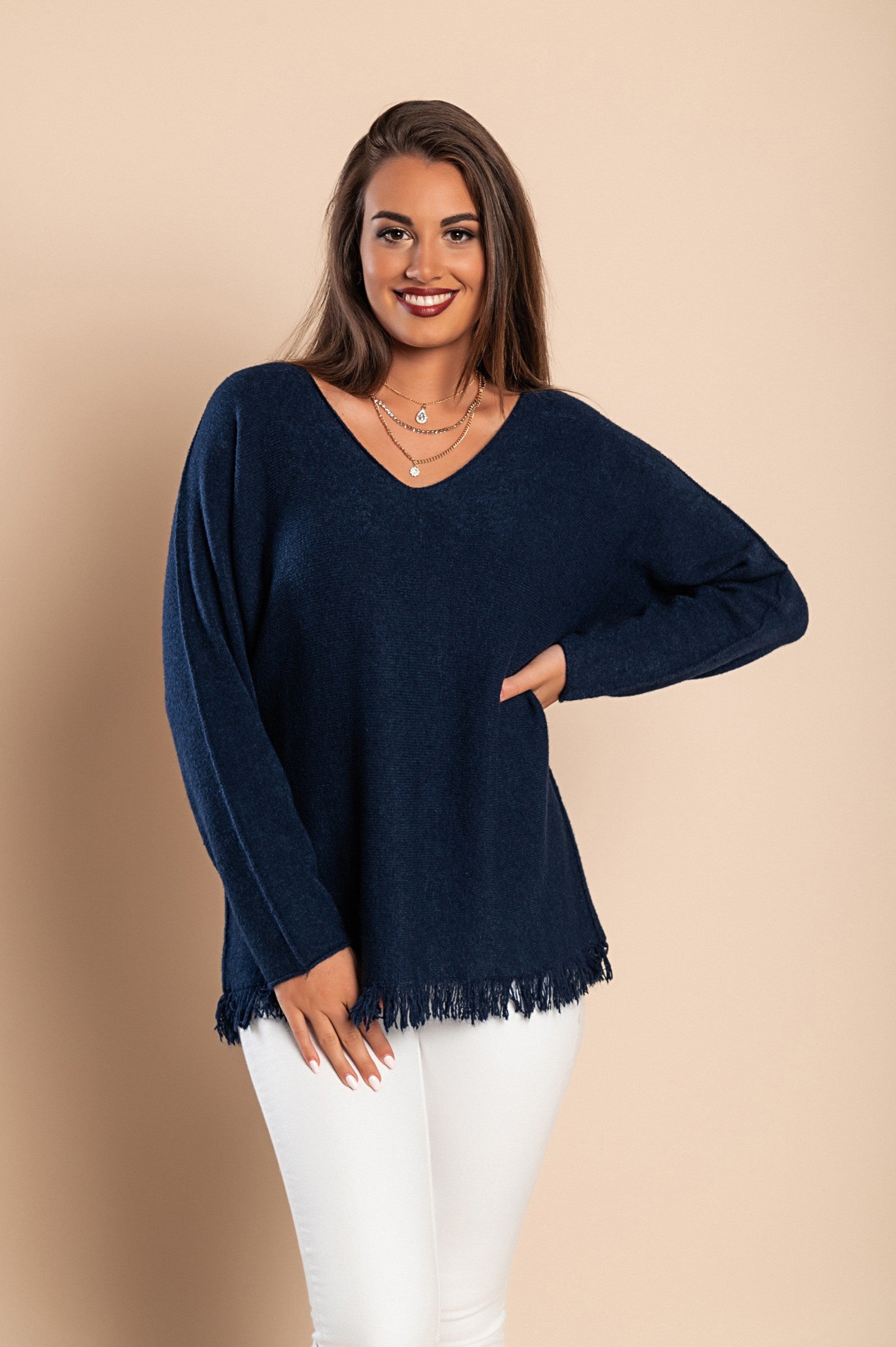 Dark blue fringed sweater with long sleeves and V-neckline, showcasing stylish tassels at the bottom.