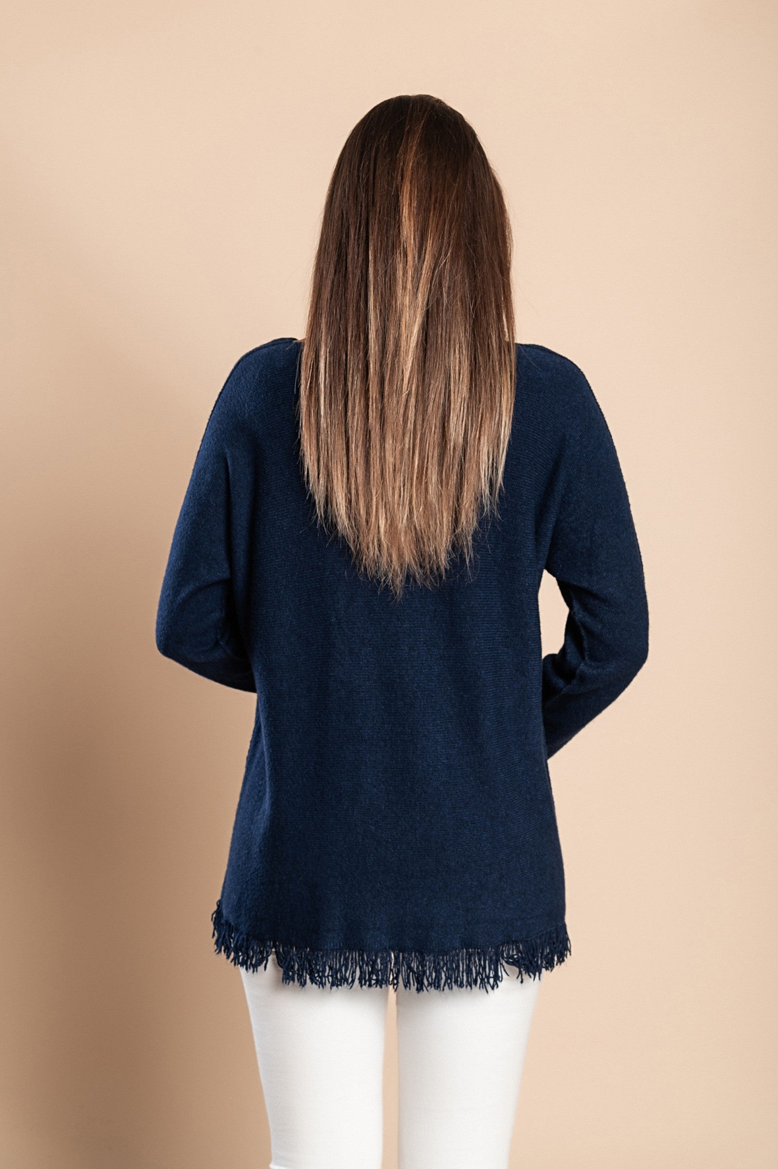 Dark blue fringed sweater with long sleeves and V-neckline, showcasing stylish tassels at the bottom.