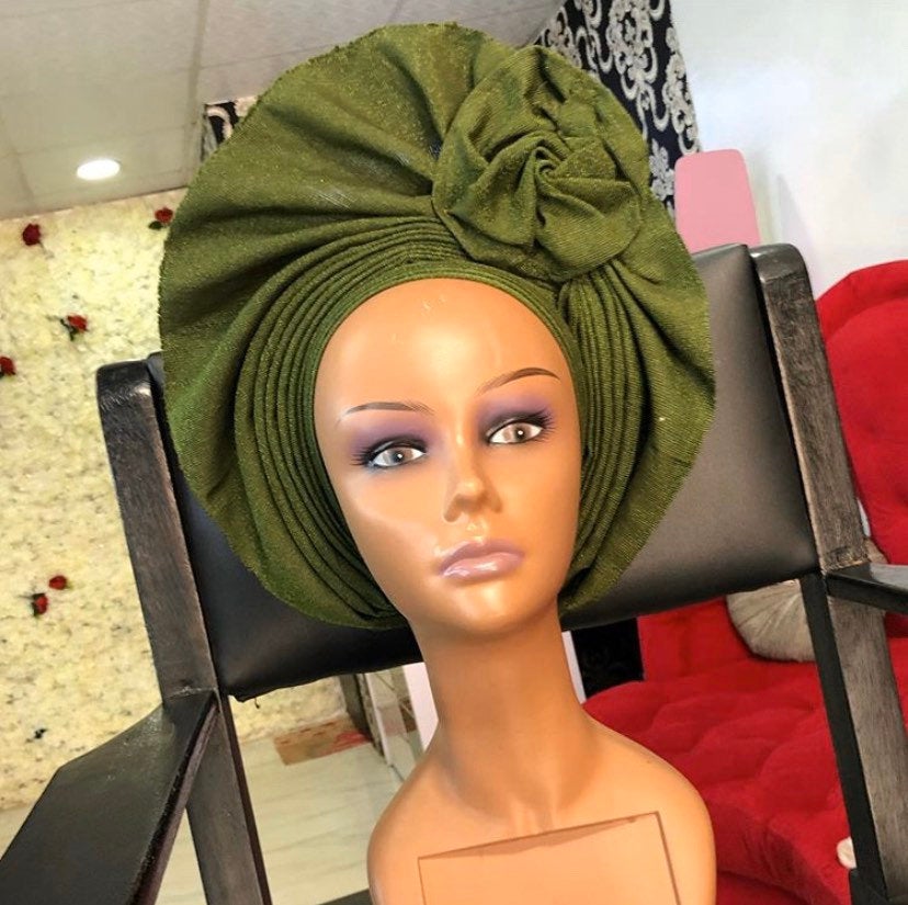 A stylish Gele Hat made from premium asooke fabric, showcasing vibrant colors and elegant design, suitable for all ages.