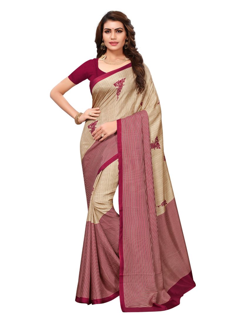 Woman wearing beige and maroon saree.