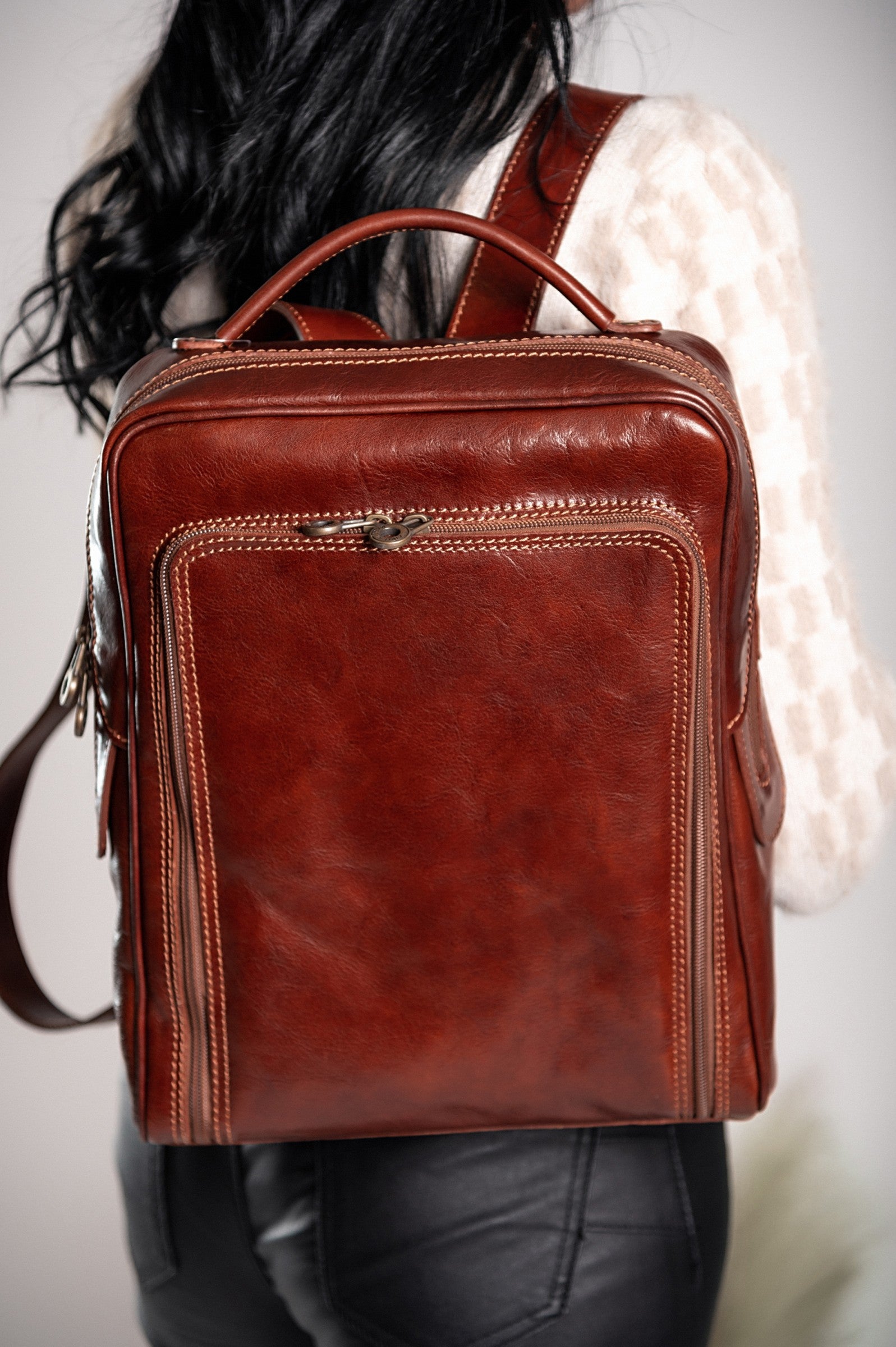 Mackenzie genuine leather bag in brown, showcasing its elegant design and practical compartments.