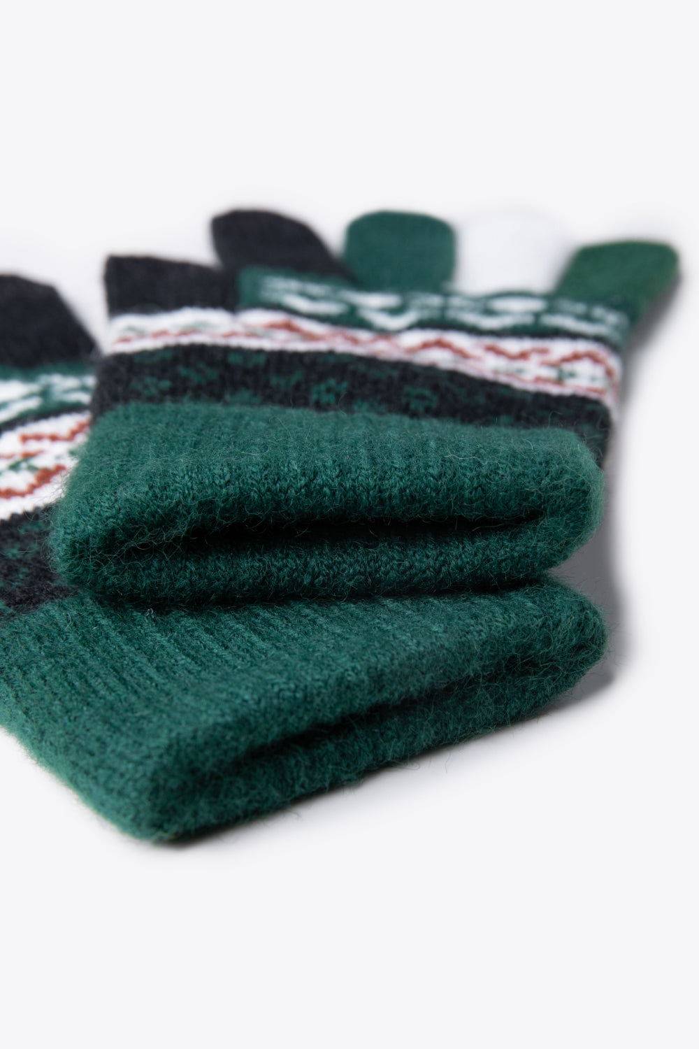 A flat lay of Geometric Five-Finger Knit Gloves showcasing their stylish design and soft acrylic material.