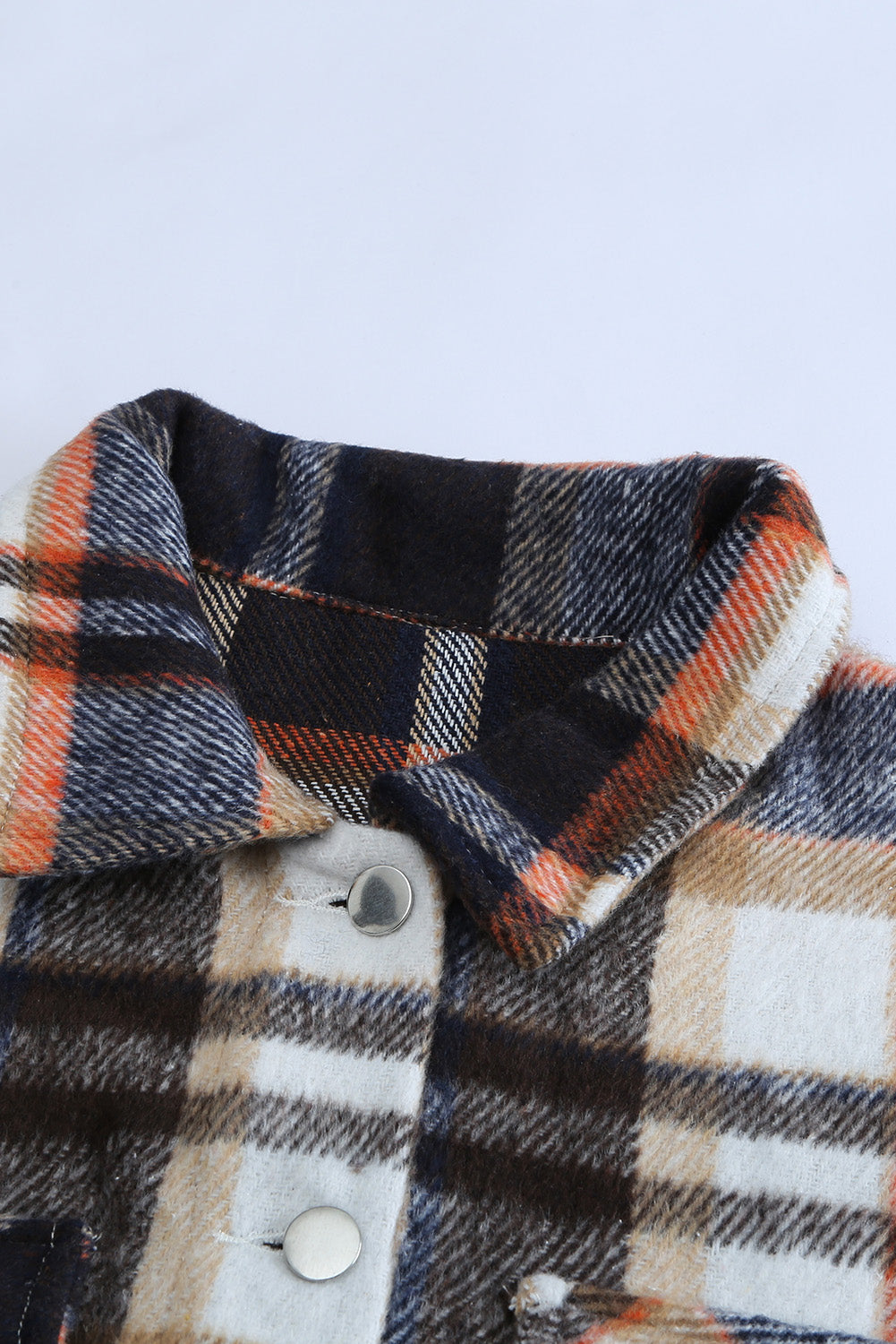 A cozy Geometric Plaid Print Pocketed Shacket featuring a classic plaid pattern, button front, and large pockets, perfect for chilly weather.