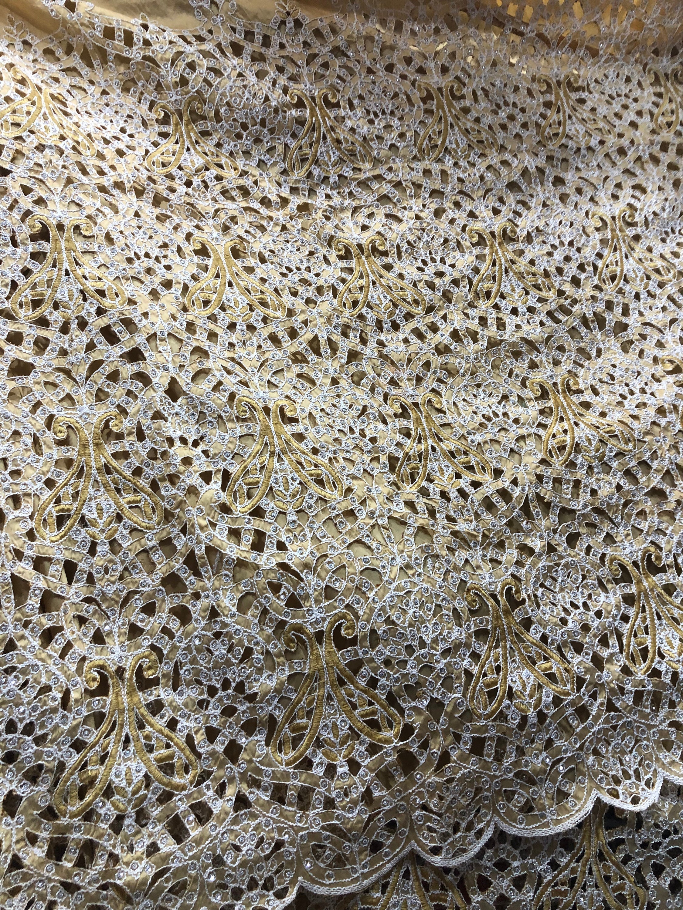 Ornate gold and white lace fabric