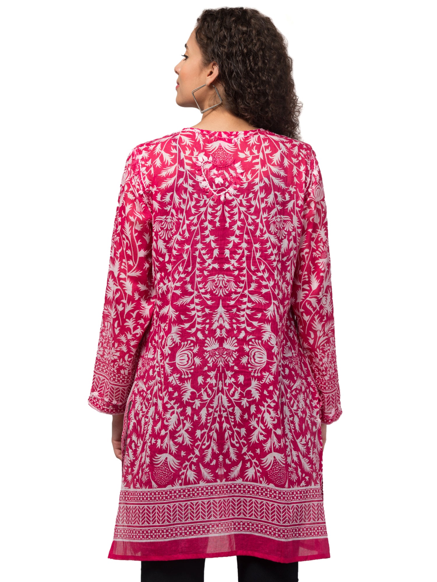 The Gia Tunic Top in vibrant hot pink, featuring intricate hand-embroidery by artisans, made from sustainably sourced cotton.