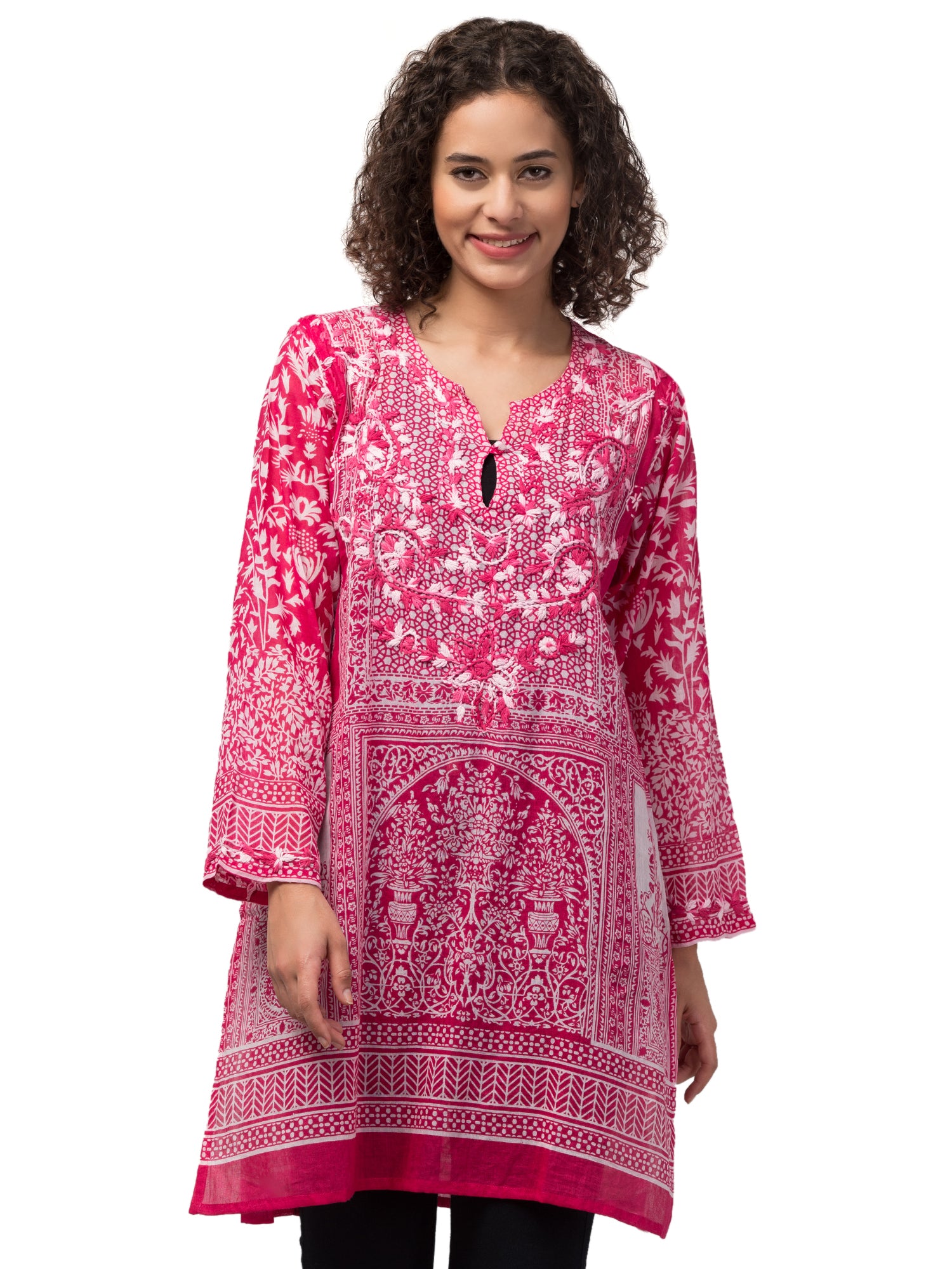 The Gia Tunic Top in vibrant hot pink, featuring intricate hand-embroidery by artisans, made from sustainably sourced cotton.