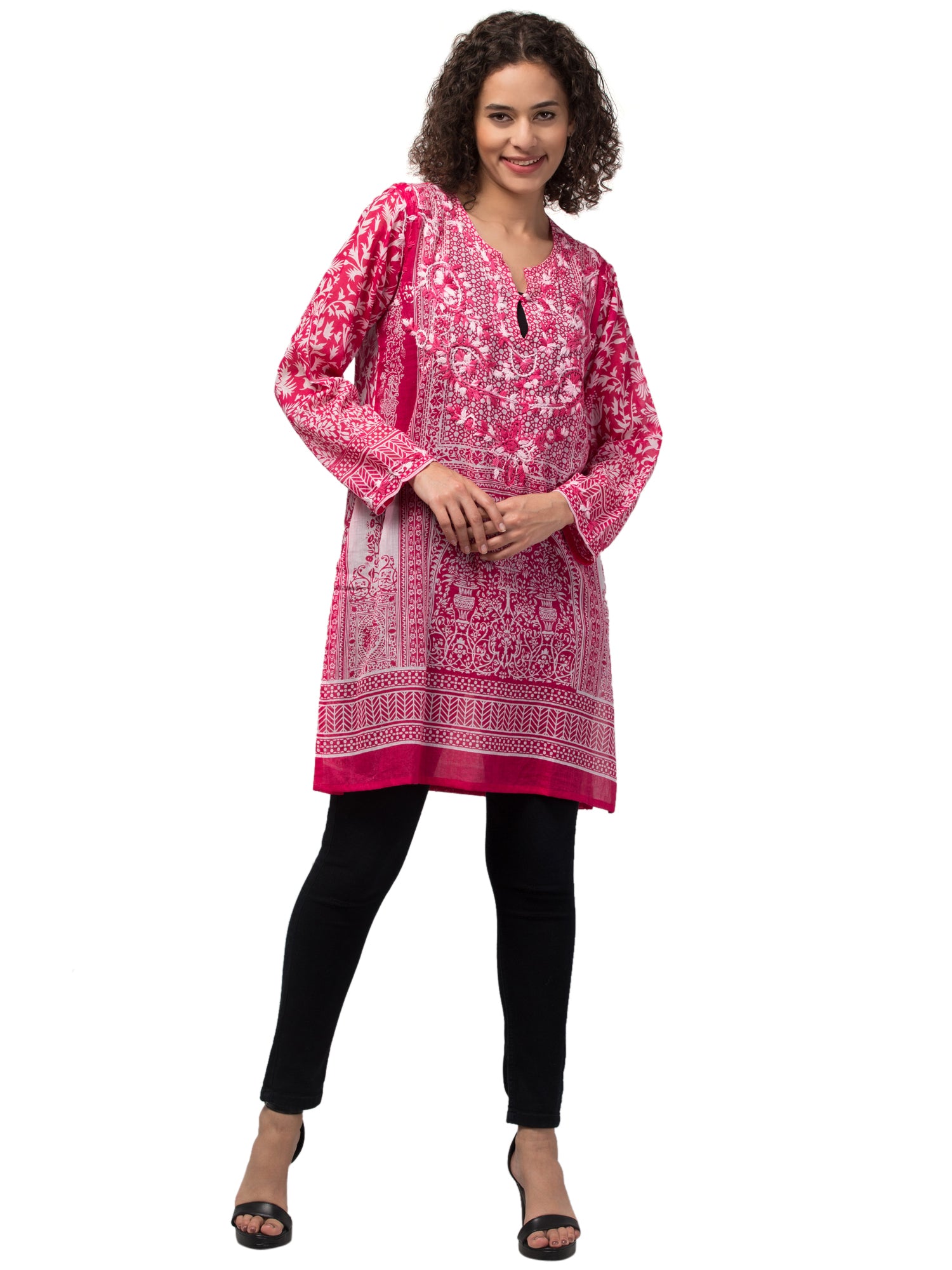 The Gia Tunic Top in vibrant hot pink, featuring intricate hand-embroidery by artisans, made from sustainably sourced cotton.