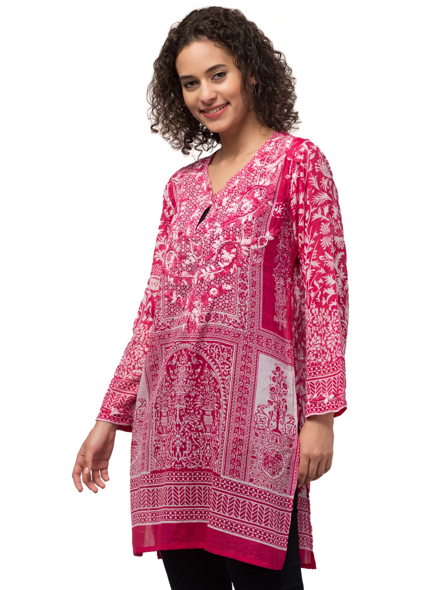 The Gia Tunic Top in vibrant hot pink, featuring intricate hand-embroidery by artisans, made from sustainably sourced cotton.