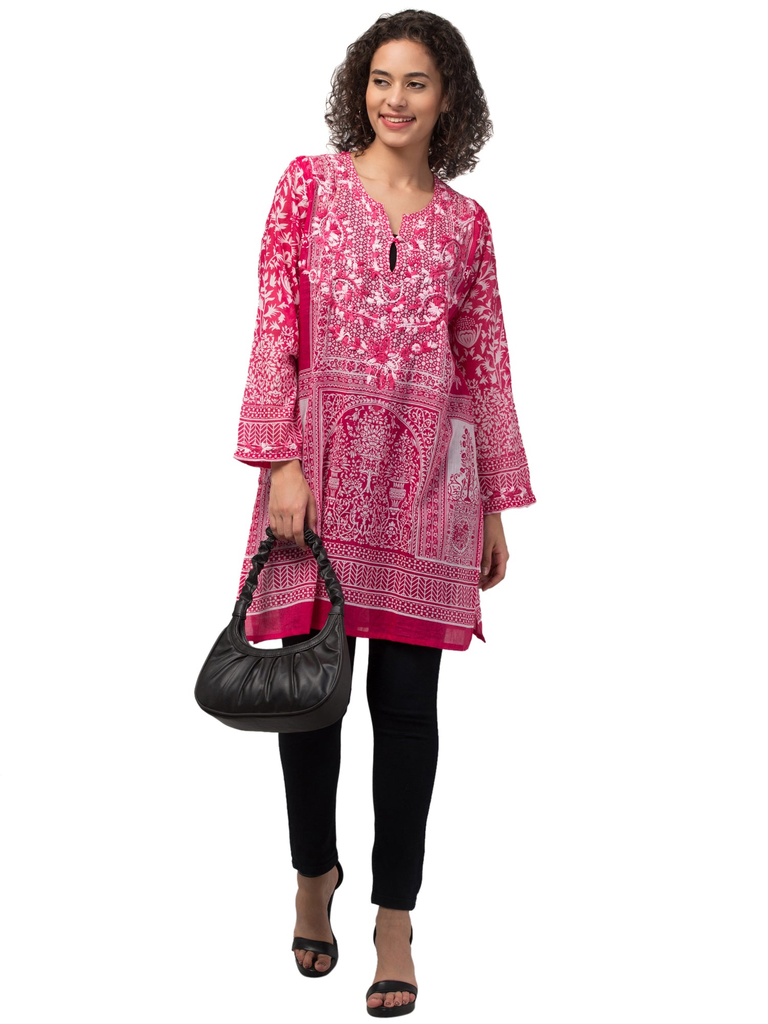 The Gia Tunic Top in vibrant hot pink, featuring intricate hand-embroidery by artisans, made from sustainably sourced cotton.