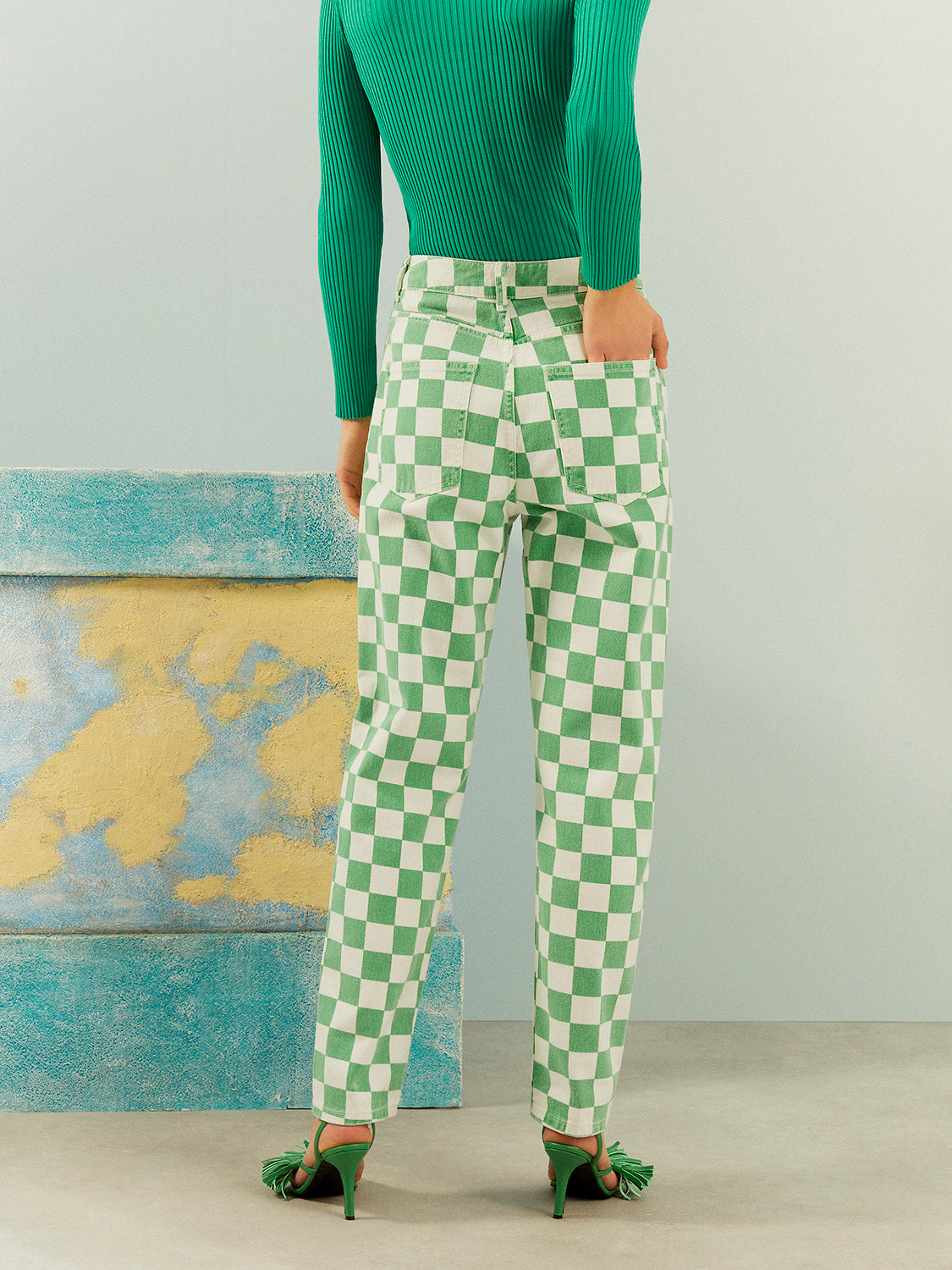 A pair of stylish Gingham Mom Jeans featuring a high-waisted design, five pockets, and a vibrant green monochrome pattern.