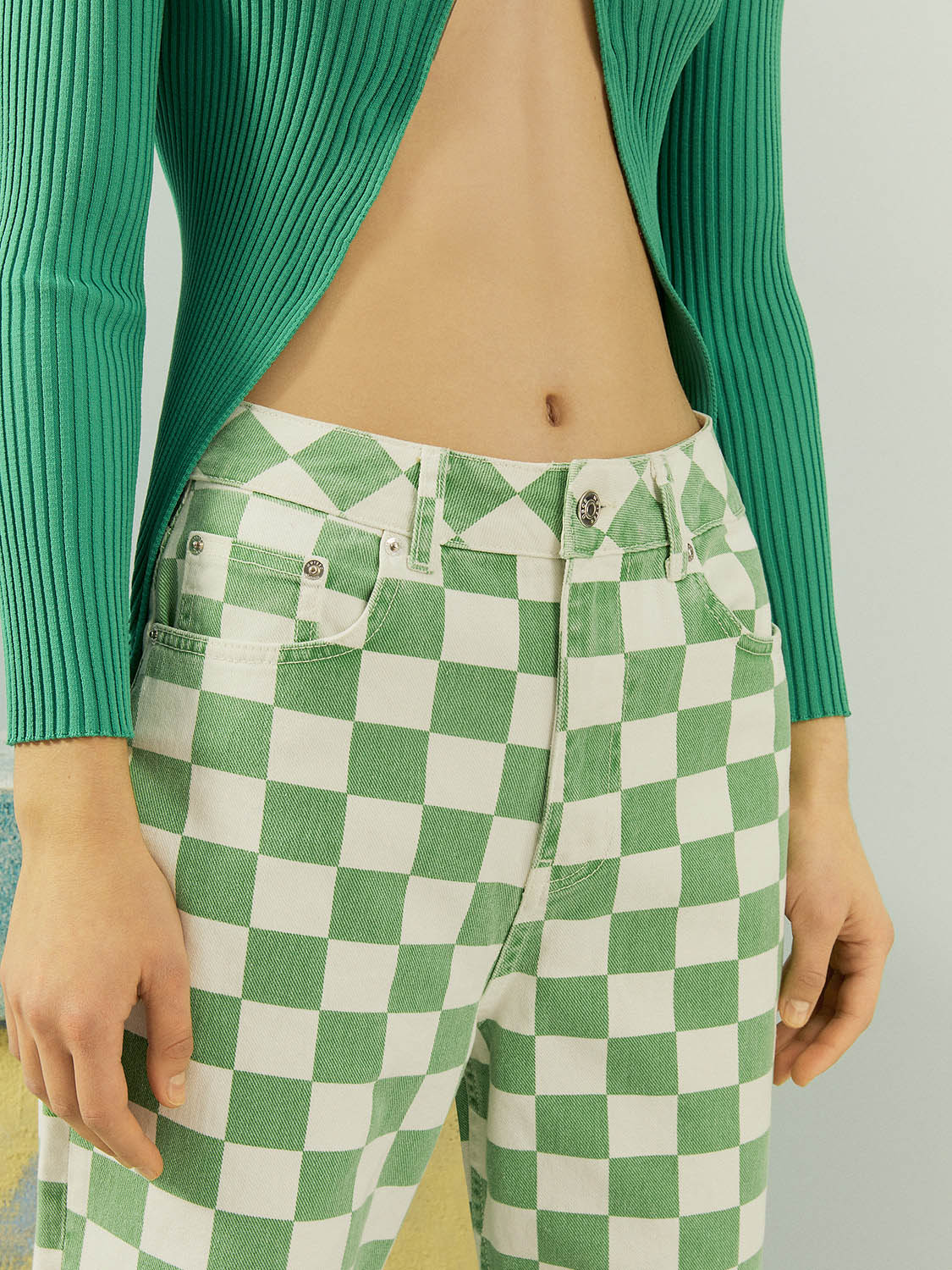 A pair of stylish Gingham Mom Jeans featuring a high-waisted design, five pockets, and a vibrant green monochrome pattern.