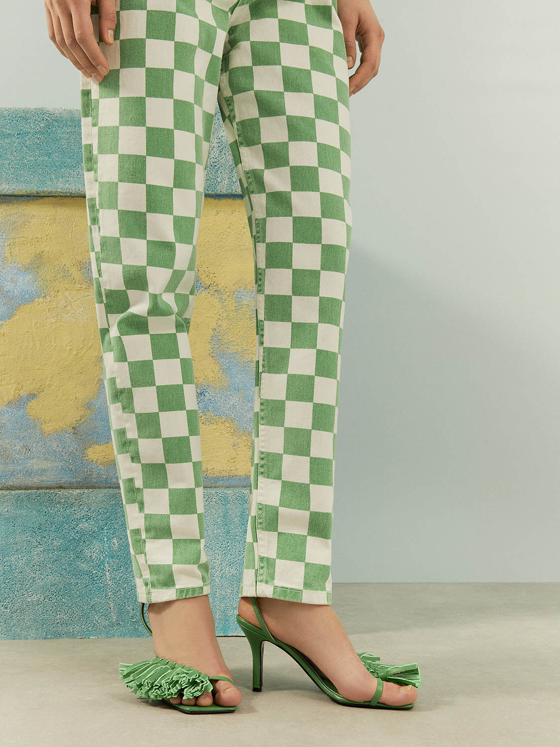 A pair of stylish Gingham Mom Jeans featuring a high-waisted design, five pockets, and a vibrant green monochrome pattern.