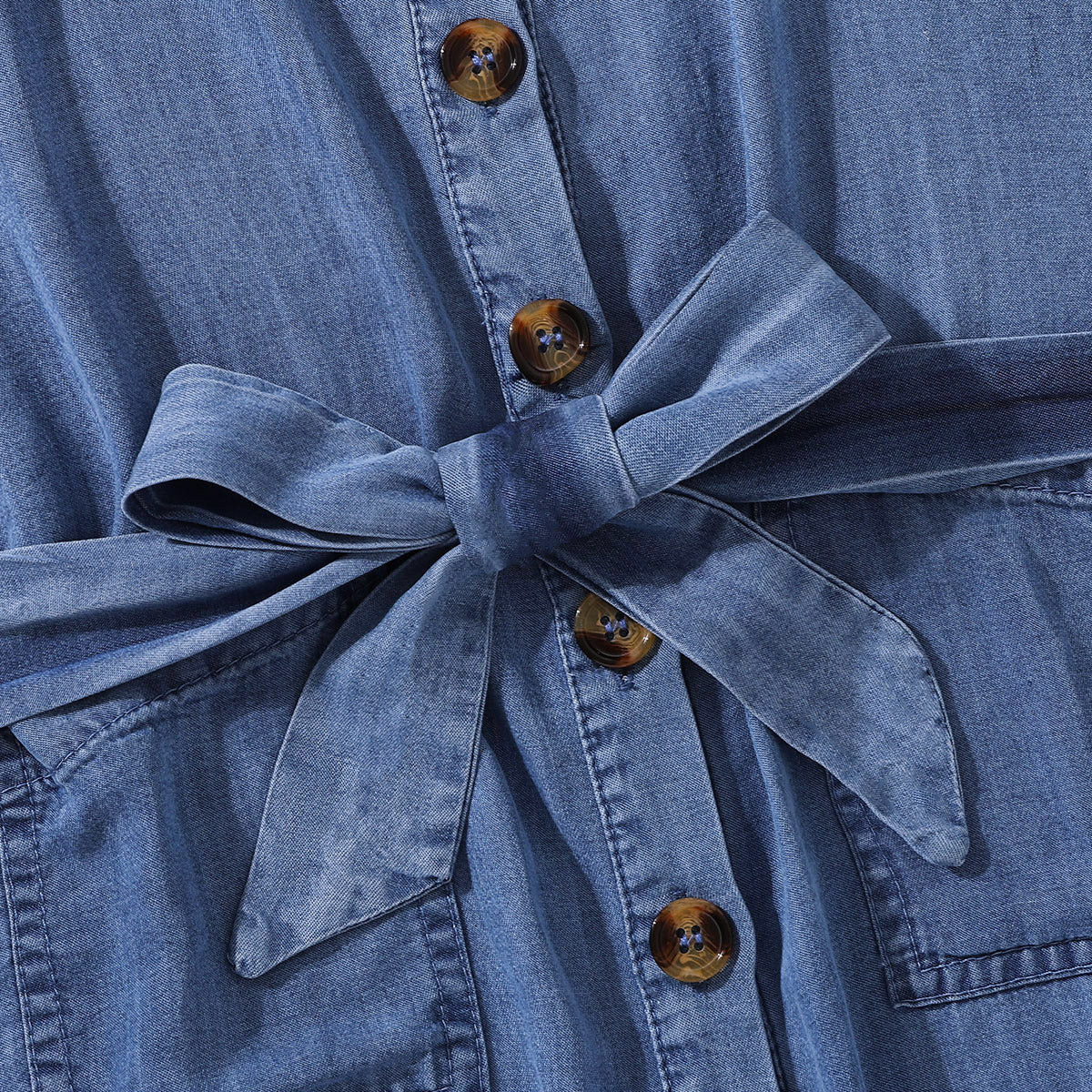 Girls Cold-Shoulder Buttoned Denim Dress featuring a square neckline and pockets, made from soft lyocell fabric.