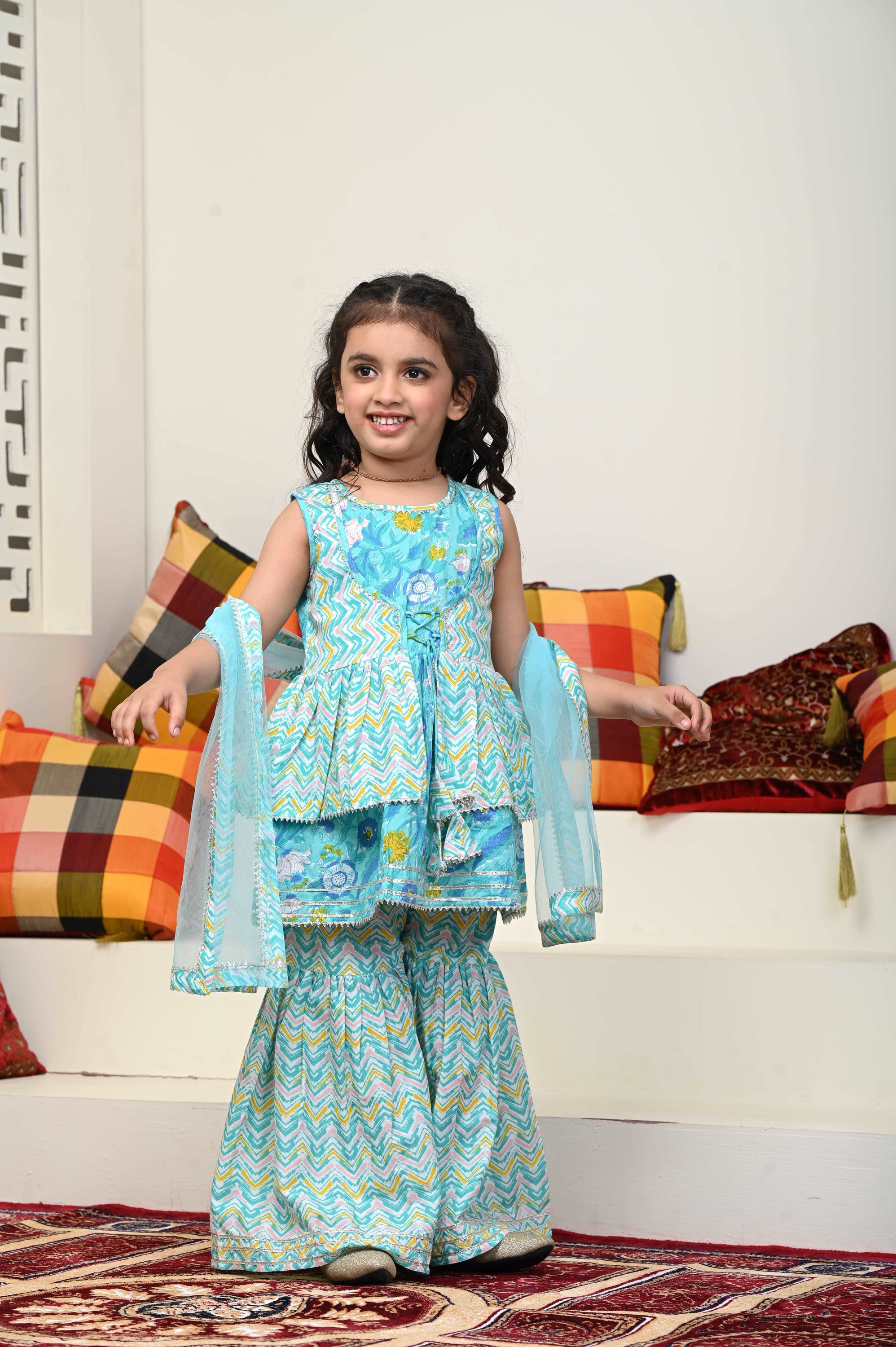 Girls Cotton Sharara Suit Set featuring vibrant colors, flared pants, and a matching dupatta, perfect for festive occasions.