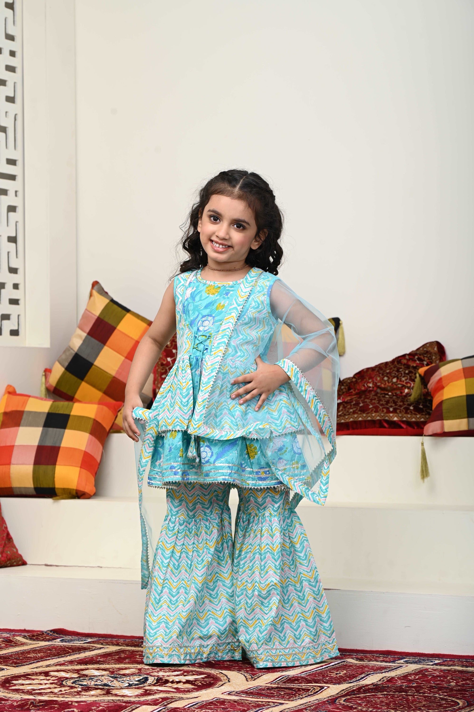 Girls Cotton Sharara Suit Set featuring vibrant colors, flared pants, and a matching dupatta, perfect for festive occasions.