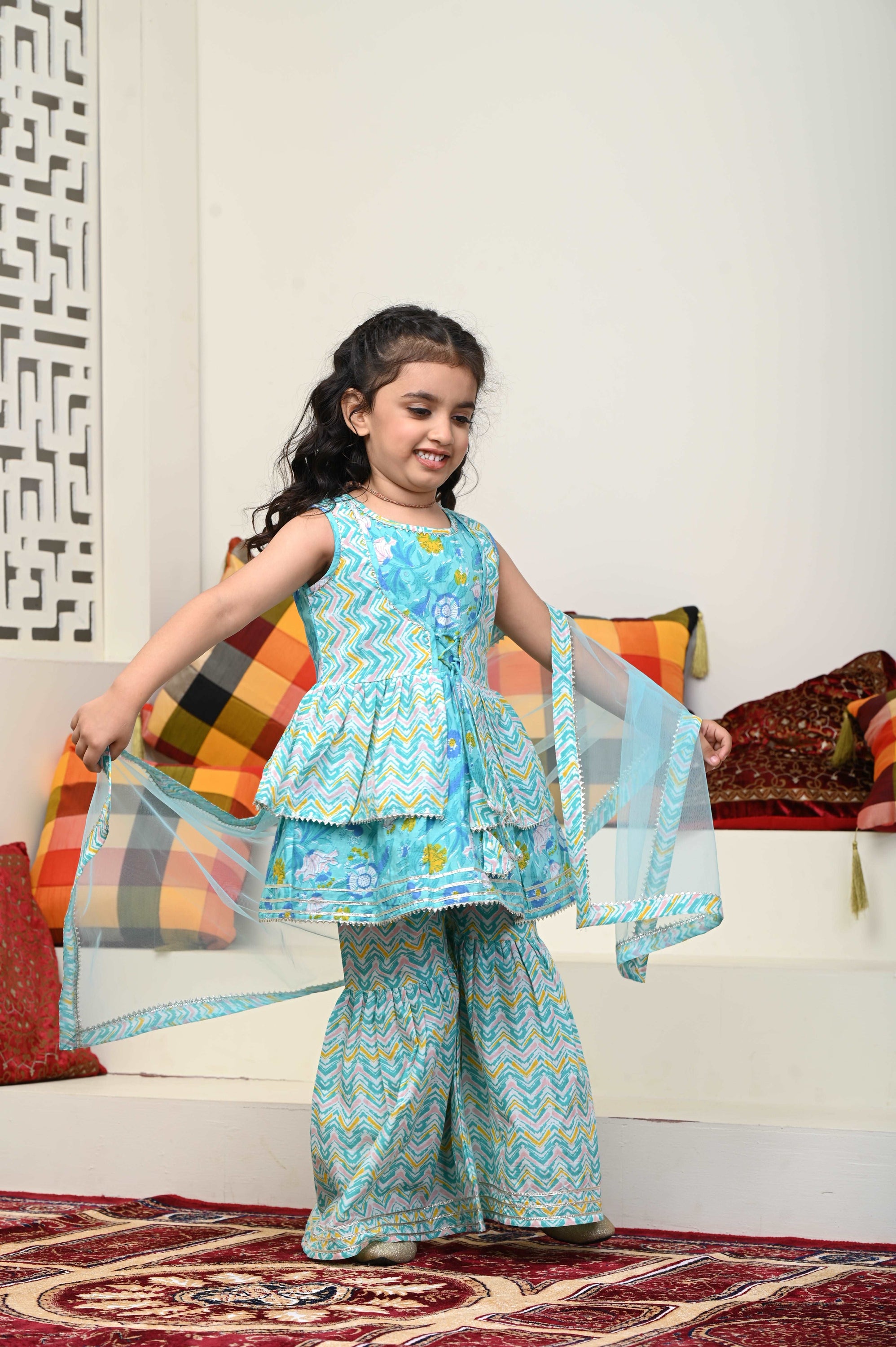 Girls Cotton Sharara Suit Set featuring vibrant colors, flared pants, and a matching dupatta, perfect for festive occasions.