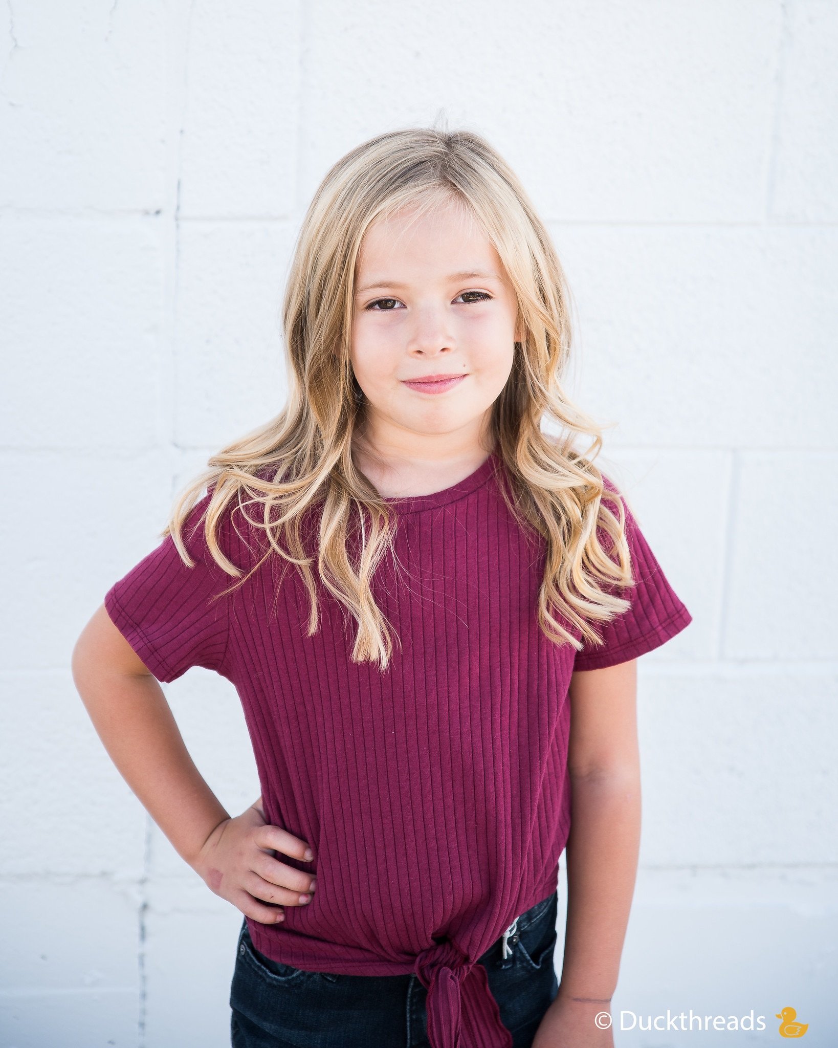 Girls Ribbed Tie Bottom Tee in Pink and Burgundy, showcasing soft ribbed fabric and stylish tie bottom design.