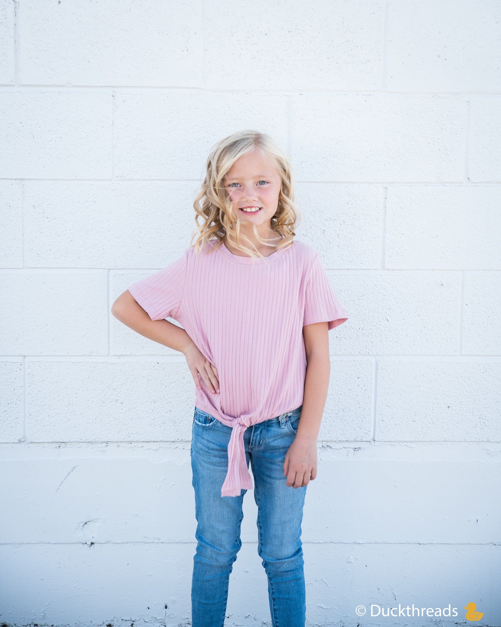 Girls Ribbed Tie Bottom Tee in Pink and Burgundy, showcasing soft ribbed fabric and stylish tie bottom design.