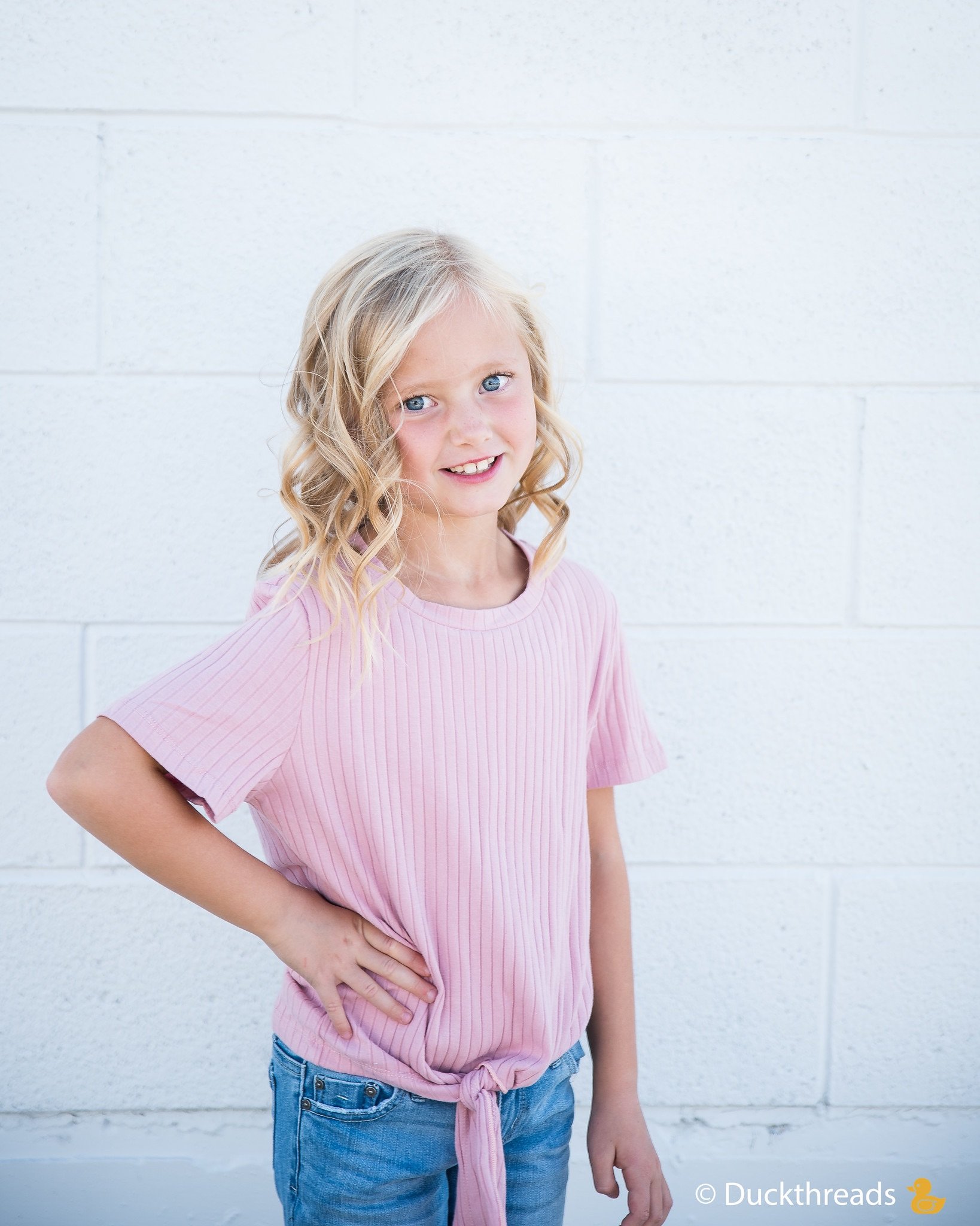 Girls Ribbed Tie Bottom Tee in Pink and Burgundy, showcasing soft ribbed fabric and stylish tie bottom design.