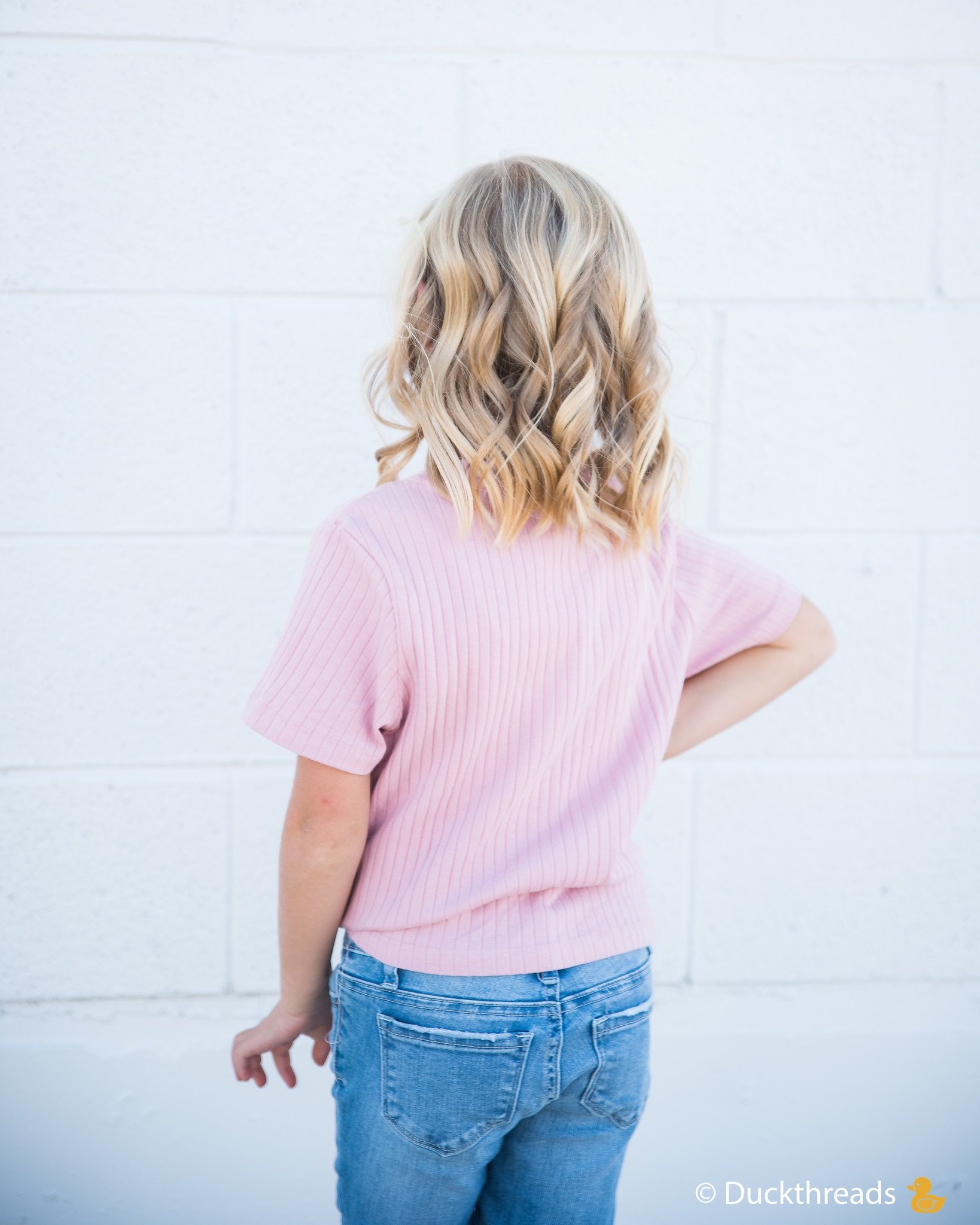 Girls Ribbed Tie Bottom Tee in Pink and Burgundy, showcasing soft ribbed fabric and stylish tie bottom design.