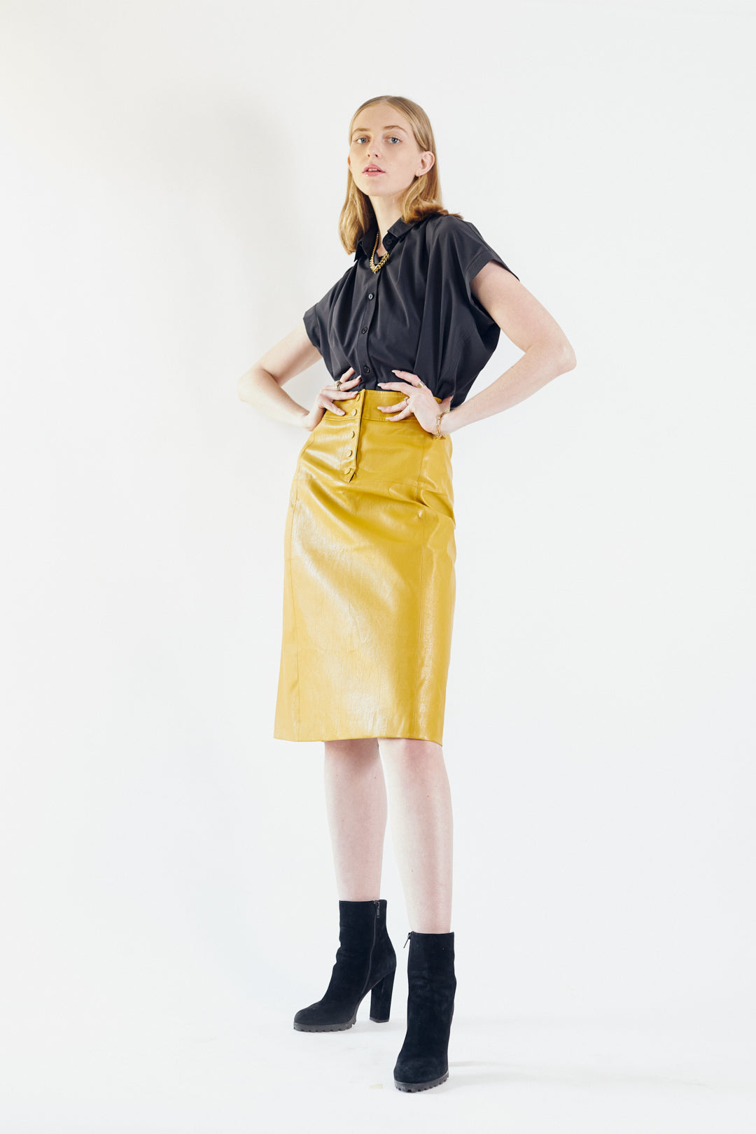 Glossy Vegan Leather Pencil Skirt in mustard color, featuring a stylish front-panel detail and front button fastening.