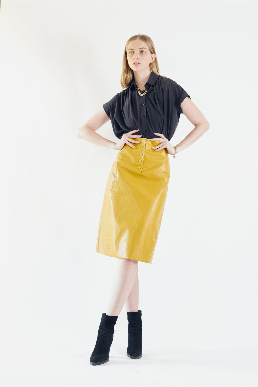 Glossy Vegan Leather Pencil Skirt in mustard color, featuring a stylish front-panel detail and front button fastening.