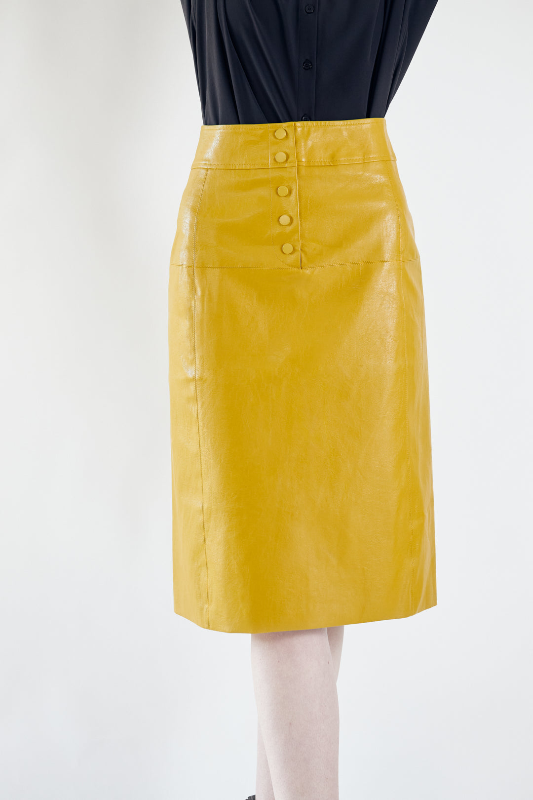 Glossy Vegan Leather Pencil Skirt in mustard color, featuring a stylish front-panel detail and front button fastening.