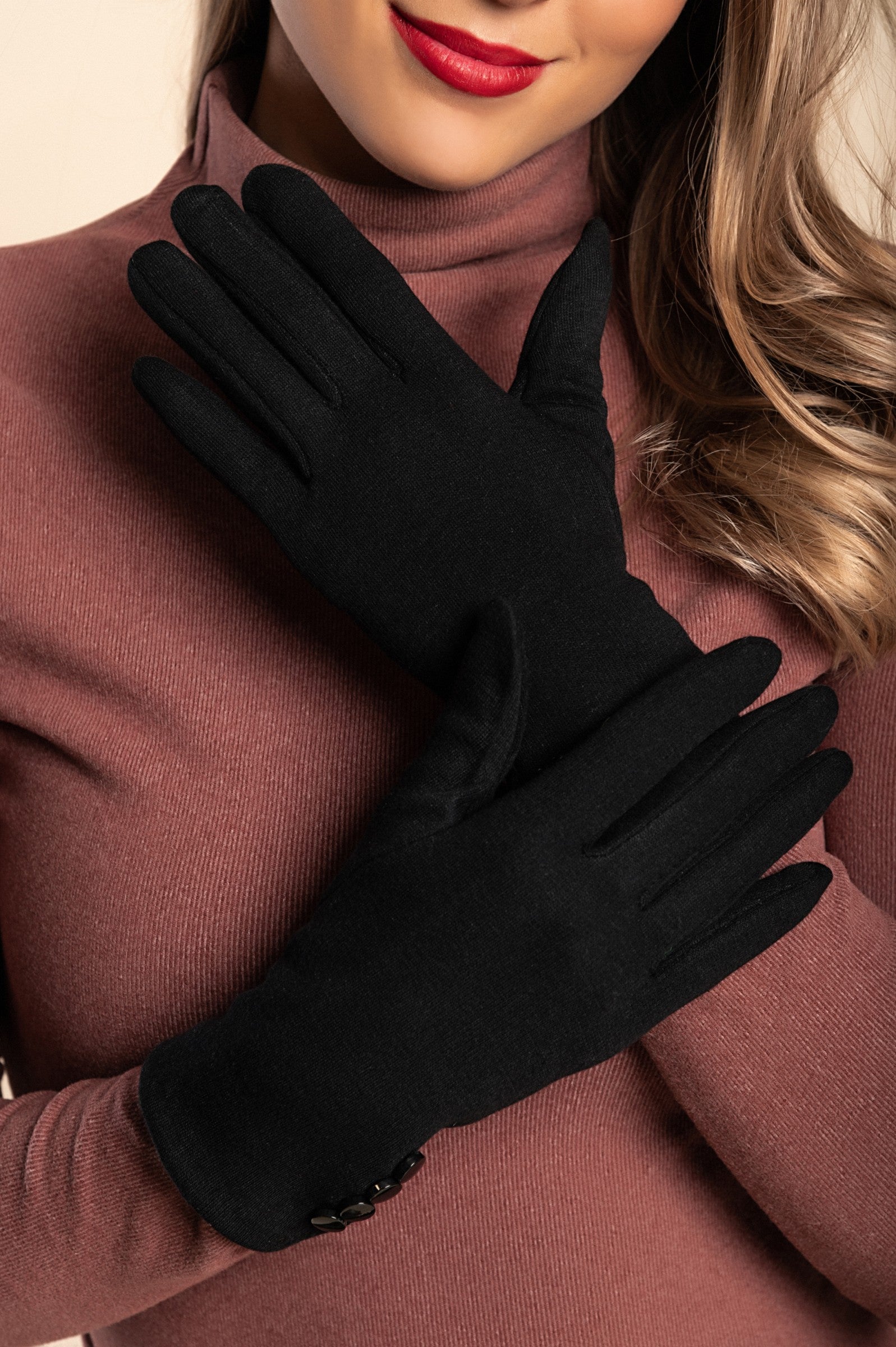 Elegant black gloves featuring decorative buttons, made from soft and warm fabric.